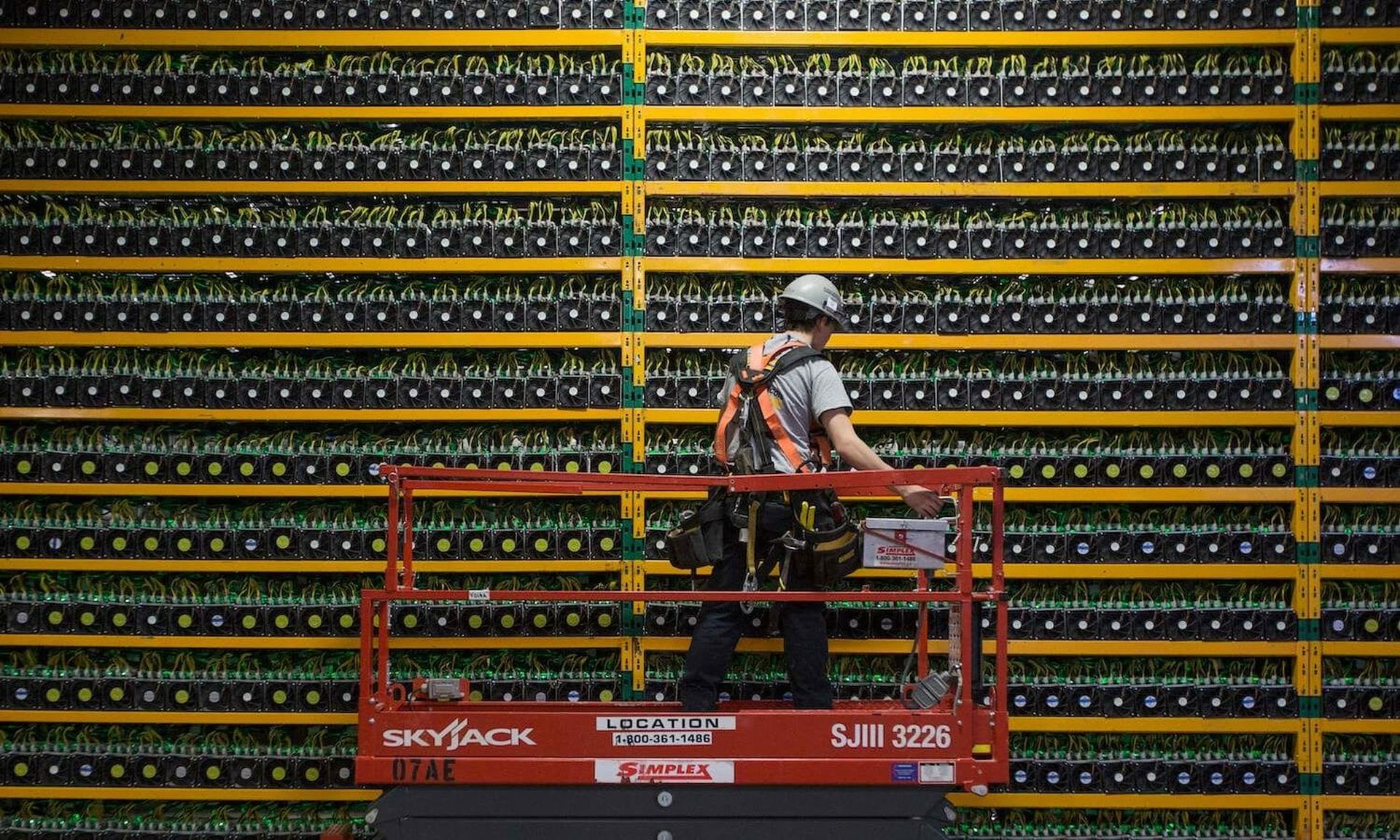 A technician inspects the backside of a cryptocurrency mining farm in Saint Hyacinthe, Quebec. Talos discovered a new cryptocurrency-mining botnet attack, Prometei, that bypasses detection systems and monetizes its campaigns in less intrusive ways. (LARS HAGBERG/AFP via Getty Images)