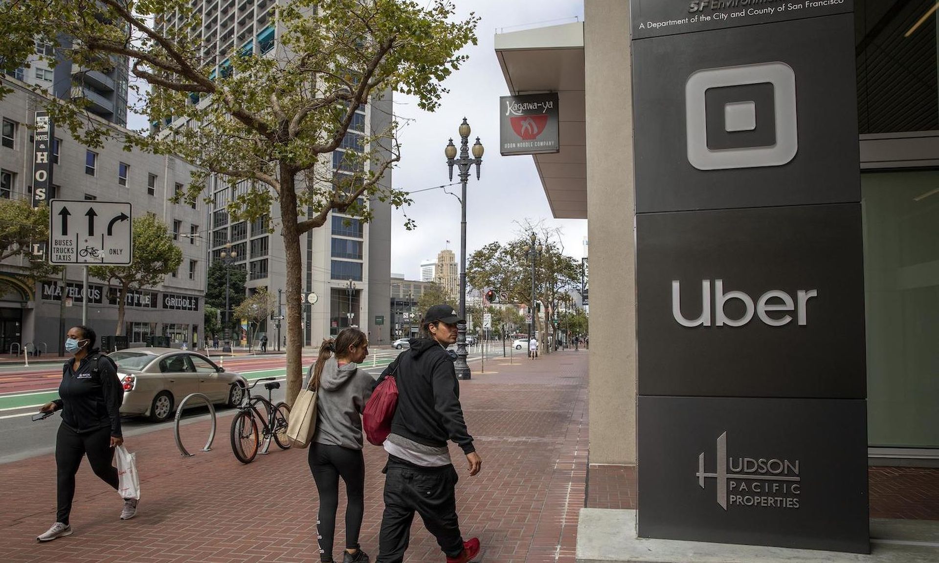 Pedestrians walk past a signage displayed outside Uber Technologies headquarters on August 10, 2020 in San Francisco, California. Federal prosecutors charged Joe Sullivan, the former chief security officer for Uber, with crimes related to an alleged cover-up of the company’s massive 2016 hack. (Photo by Liu Guanguan/China News Service via Get...