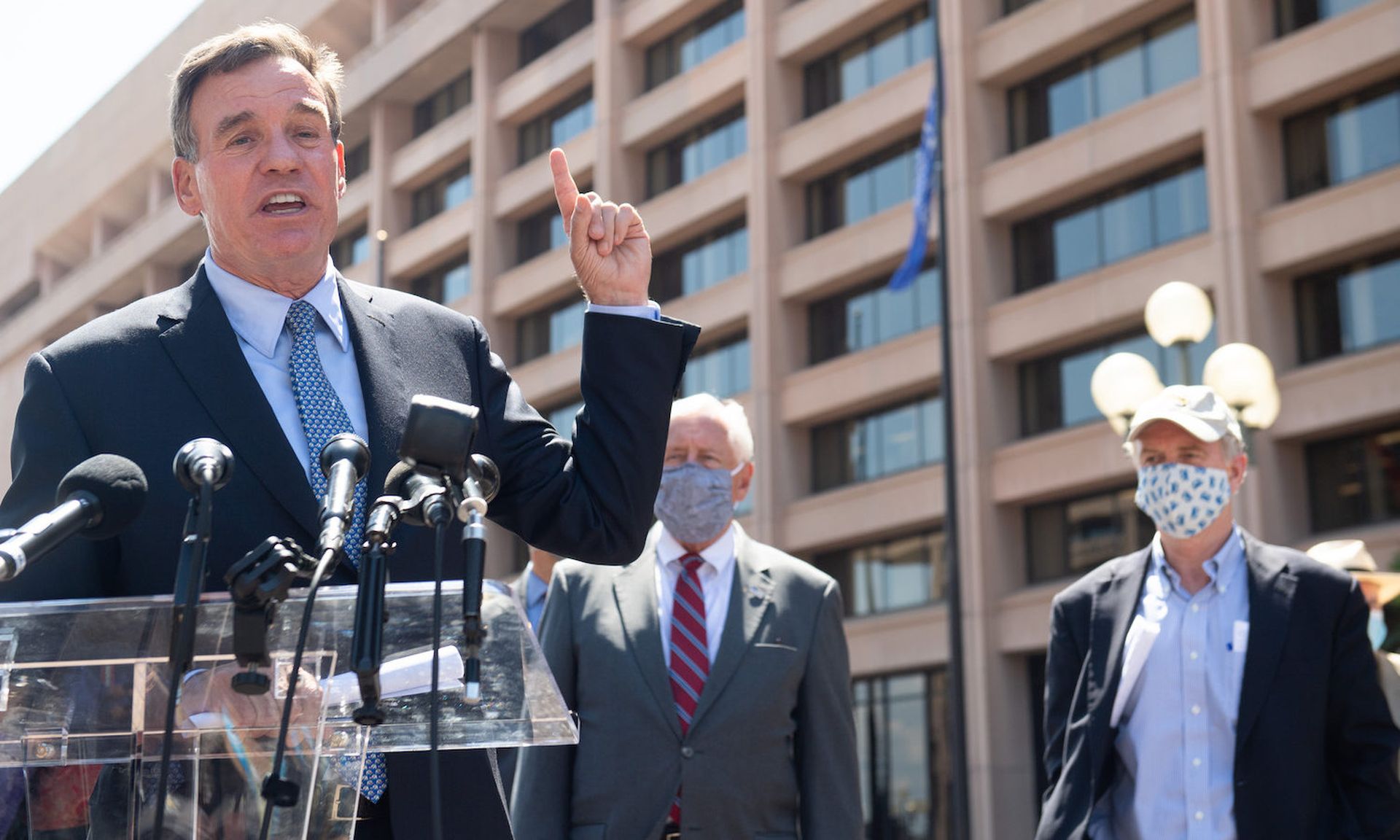 US Sen. Mark Warner, a Democrat of Virginia, speaks outside of the headquarters of the United States Postal Service (USPS) in Washington, DC, August 18, 2020. Warner is one of four legislators to introduce a bill focusing on standards for IoT devices purchased by federal agencies. (SAUL LOEB/AFP via Getty Images)