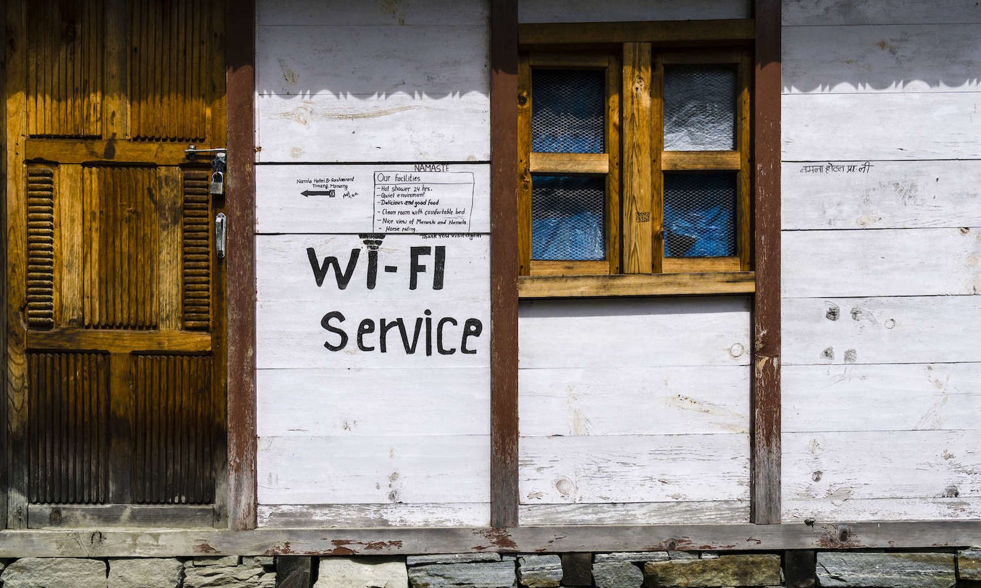 A tourist lodge with a wifi service sign at the buildings wall in Nepal. Roughly 20 percent of people in Nepal  have internet access. (Photo by Frank Bienewald/LightRocket via Getty Images)