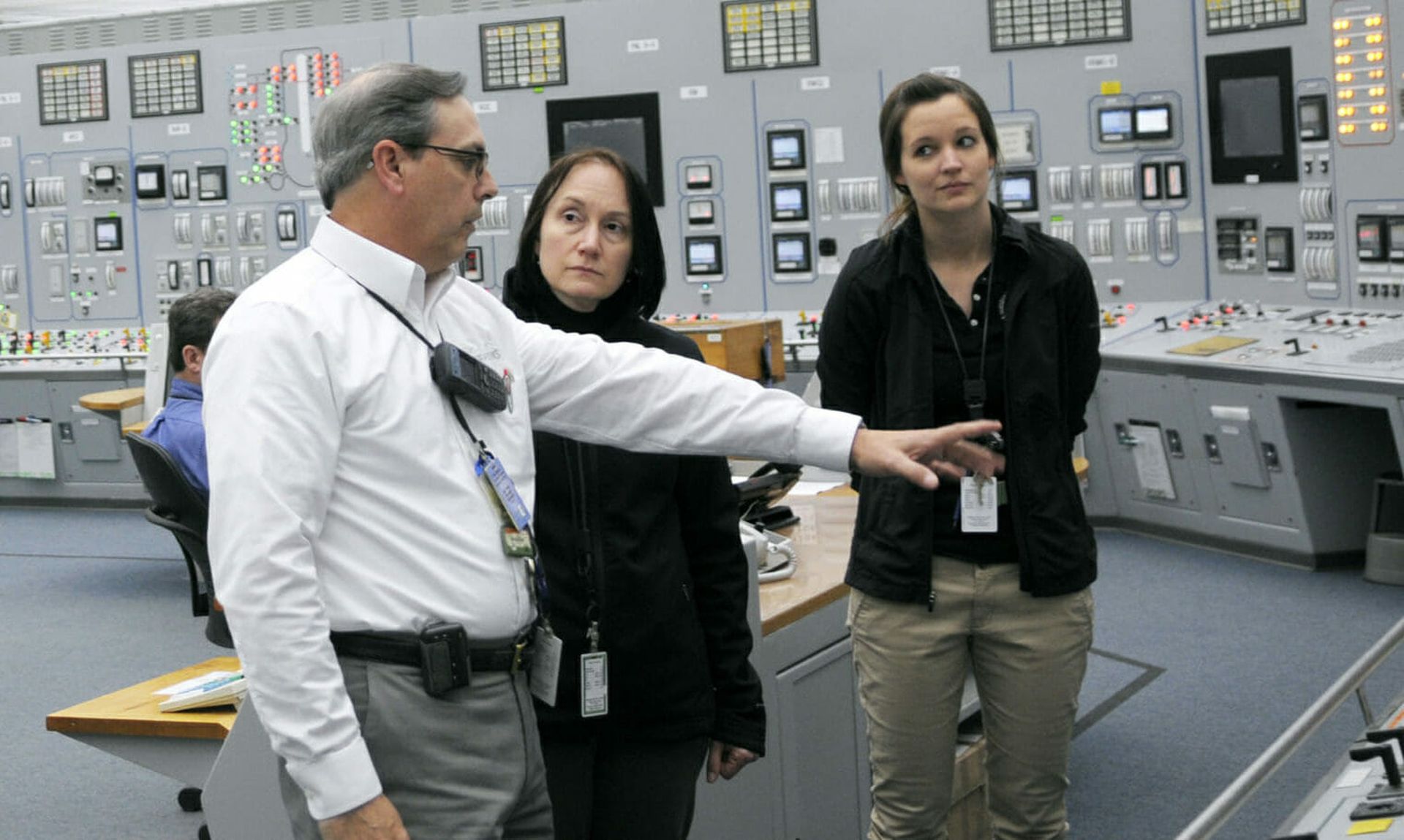 NRC Commissioner Kristine L. Svinicki (center)  listens to a plant manager discuss operations in the control room, during her tour of the of Cooper Nuclear Station in Nebraska. (NRC)