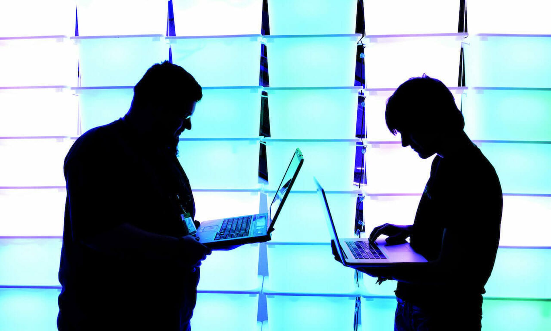 Participants hold their laptops in front of an illuminated wall at the annual Chaos Computer Club (CCC) computer hackers’ congress in Hamburg, Germany. A threat actor leveraging a new Trickbot capability could attack weaknesses in the booting process to install backdoors, firmware implants or even brick targeted devices. (Patrick Lux/Getty Im...