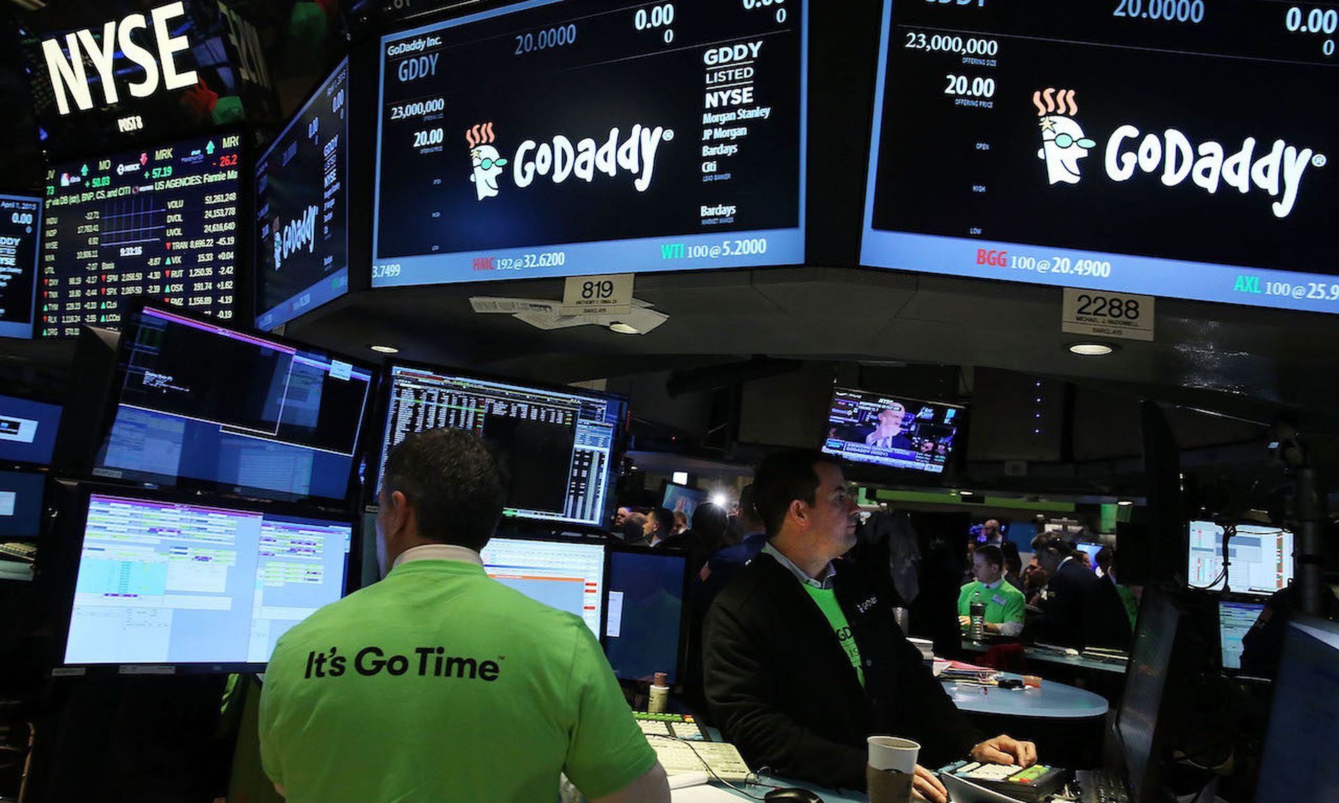 Traders work on the floor of the New York Stock Exchange as the website hosting service GoDaddy makes its initial public offering (IPO) on April 1, 2015. Earlier in 2020, scammers called up GoDaddy posing as representatives of legitimate cryptocurrency platforms, and tricked employees into changing account information so that email and web traffic ...
