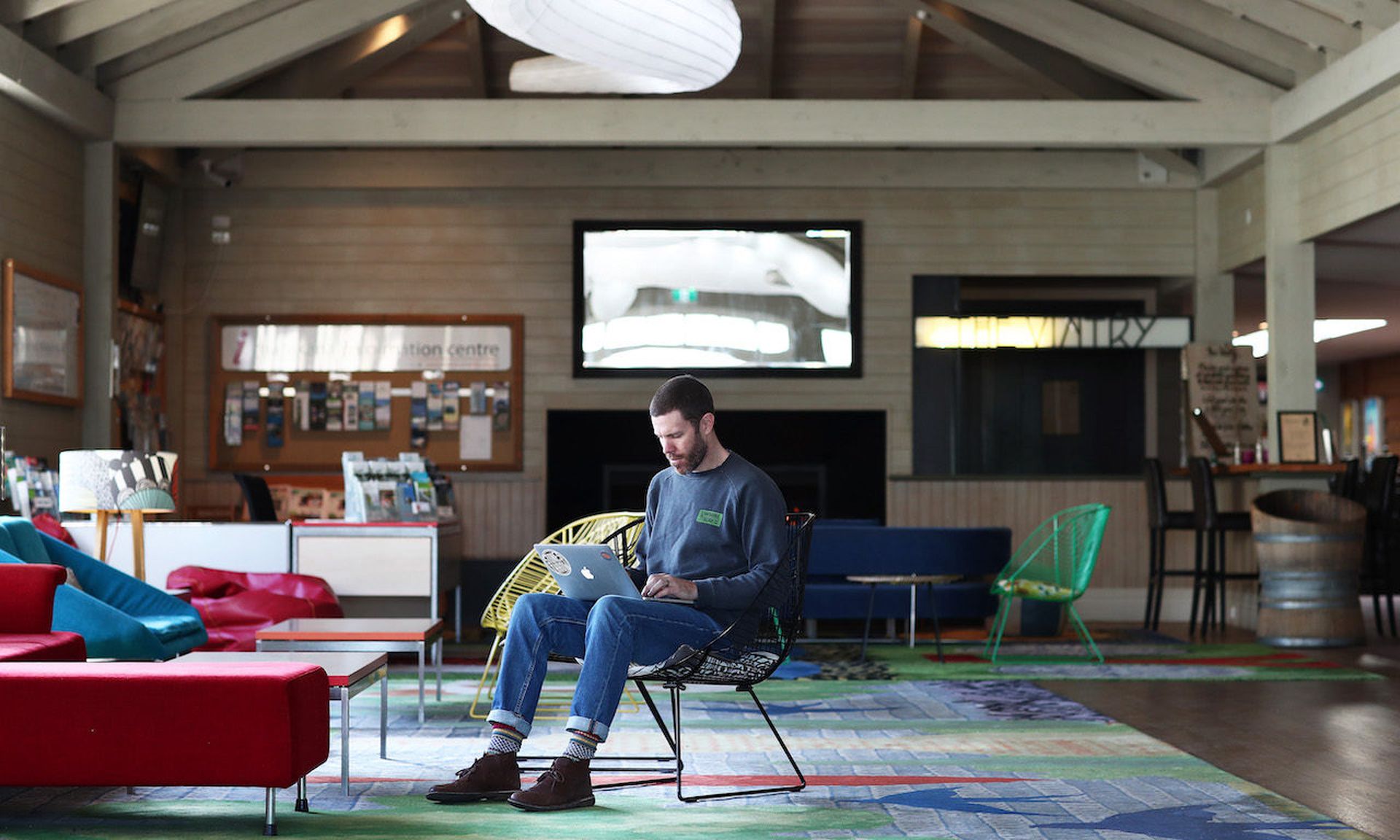 Cinema owner Dan Paine works on his laptop in the vacant cinema foyer in May 2020 in Auckland, New Zealand. (Fiona Goodall/Getty Images)