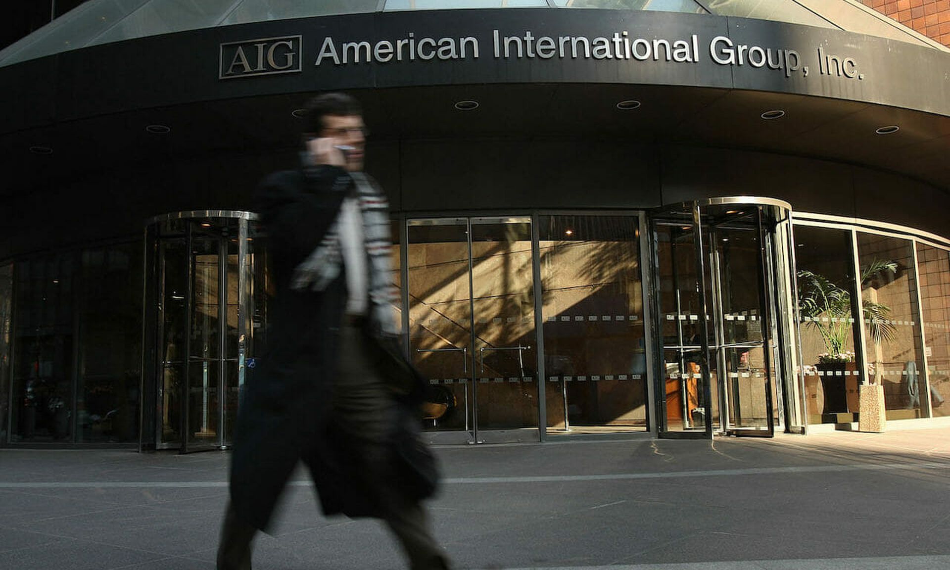 A man walks by an American International Group (AIG) building in New York City. AIG is among a number of insurance giants to provide cyber coverage. (Photo by Spencer Platt/Getty Images)