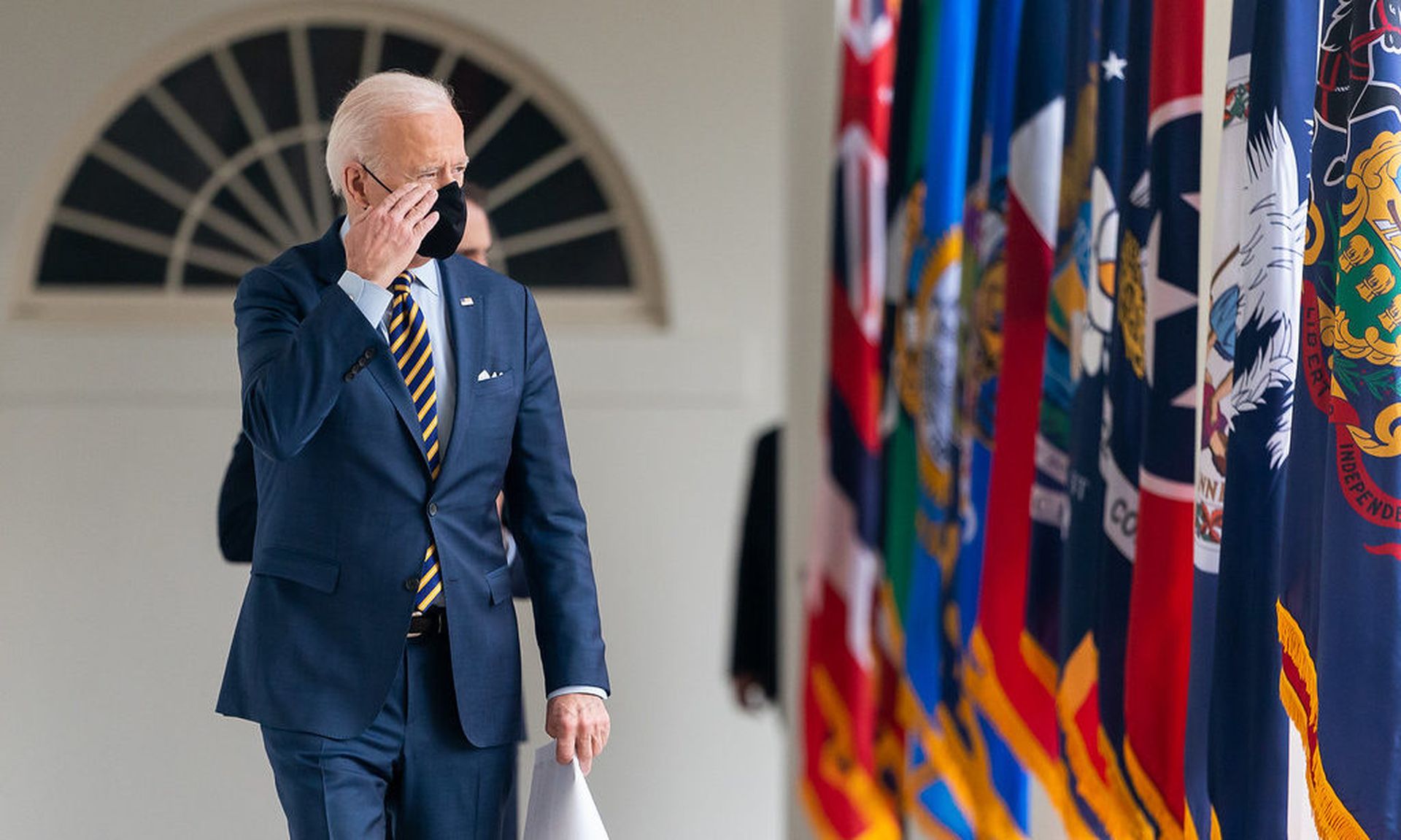 President Joe Biden salutes as he walks along the Colonnade of the White House on Friday, March 12, 2021, en route to the Oval Office. (Official White House Photo by Adam Schultz)