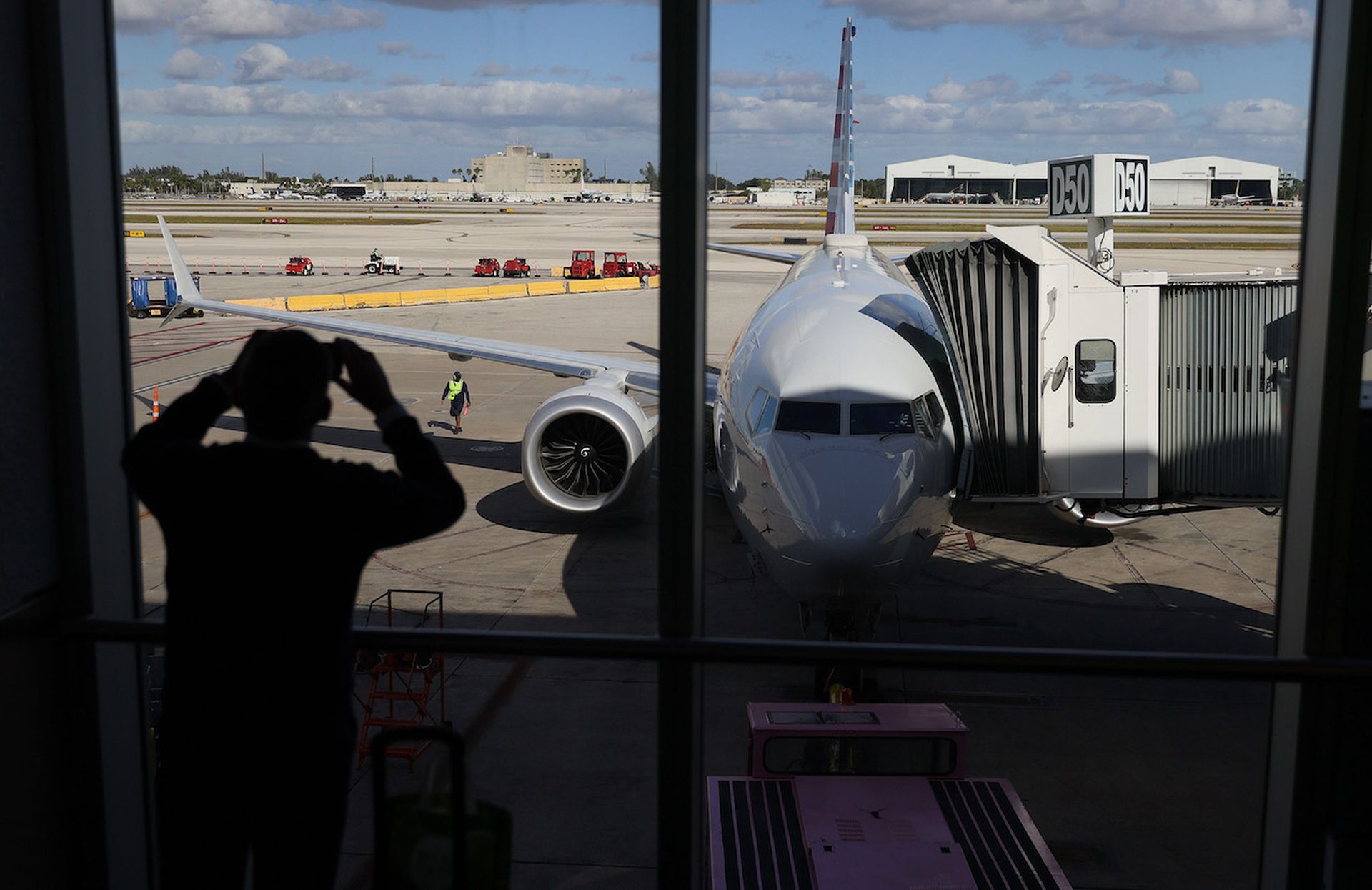 MIAMI, FLORIDA &#8211; DECEMBER 29: American Airlines flight 718, a Boeing 737 Max, is seen parked at its gate at Miami International Airport as passengers board for the flight to New York on December 29, 2020 in Miami, Florida. The Boeing 737 Max flew its first commercial flight since the aircraft was allowed to return to service nearly two years ...