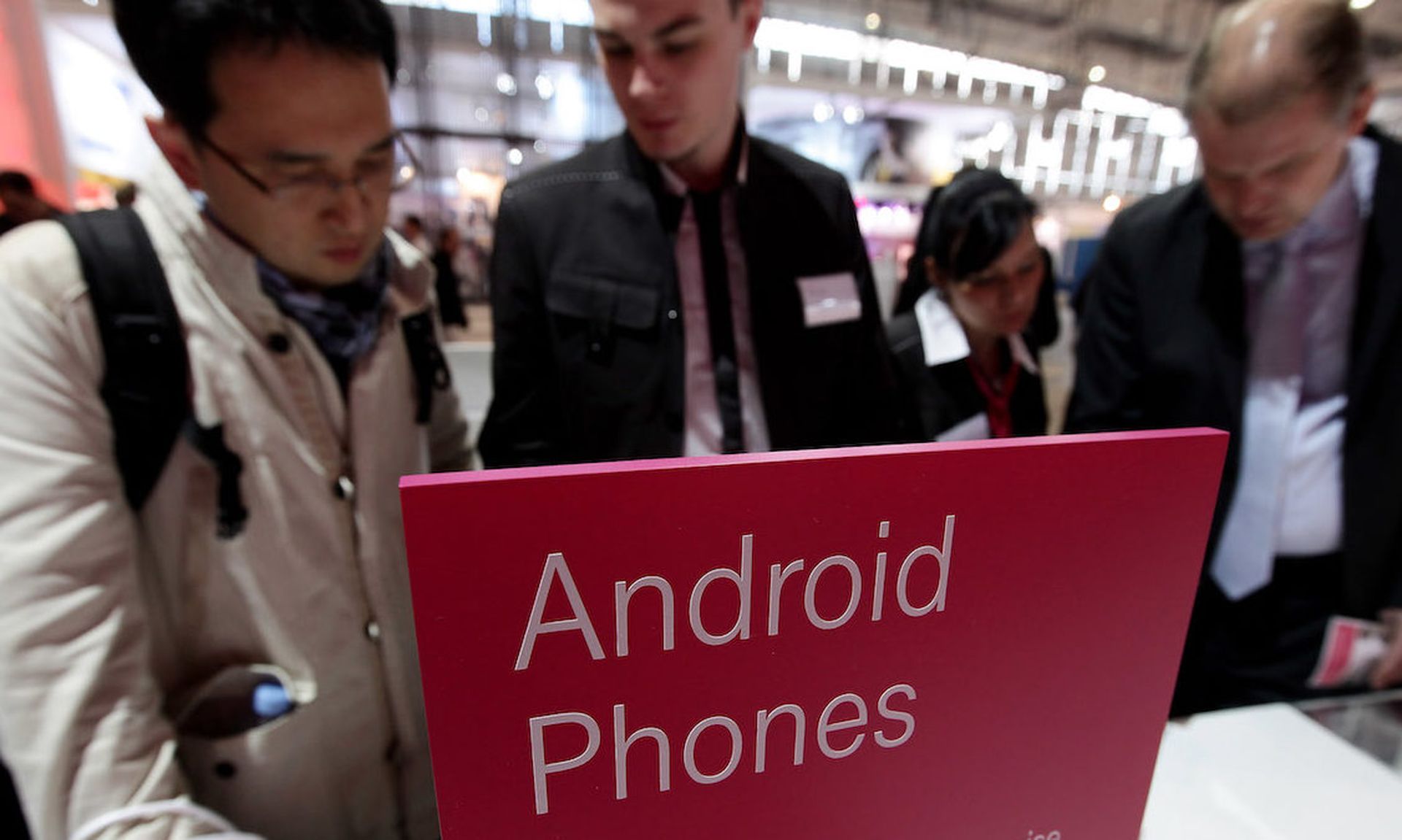 Visitors look at mobile phones using the Android operating system at the Deutsche Telekom stand at the CeBIT Technology Fair on March 2, 2010 in Hannover, Germany. (Photo by Sean Gallup/Getty Images)