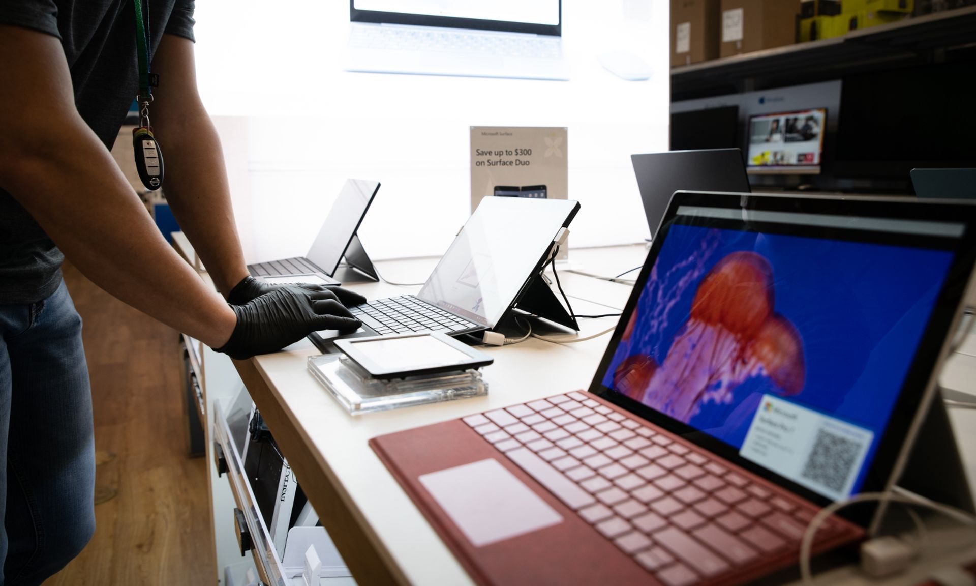 A person wearing gloves demonstrates a laptops function at a store on Nov. 27, 2020, in Louisville, Ky. A study found that nearly half of cloud privileges are misconfigured. (Jon Cherry/Getty Images)