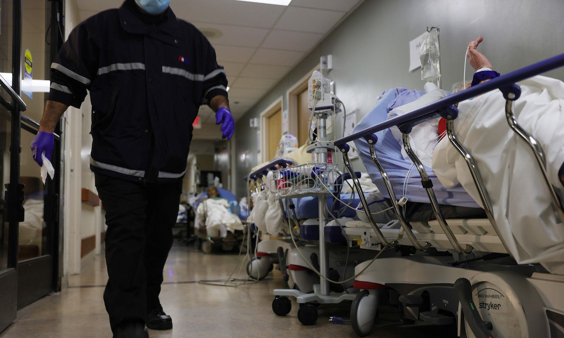 A patient lies on a stretcher in a hallway near other patients in the overloaded Emergency Room at a medical center in Southern California. Cyberattacks against health care organizations are taking a toll on resources, particularly among non profits.  (Photo by Mario Tama/Getty Images)