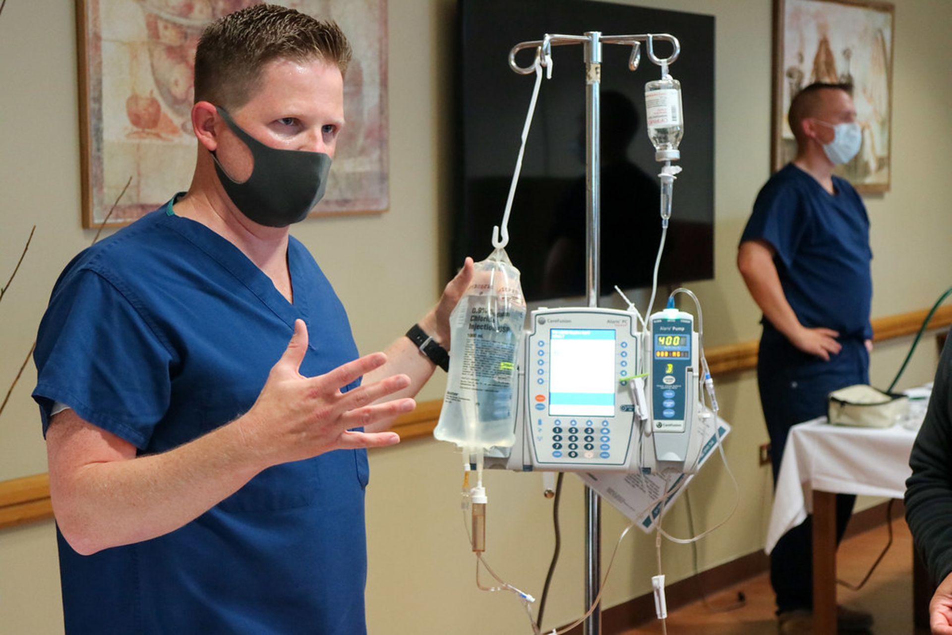 A U.S. Navy nurse explains to fellow staff members how to properly monitor and use an infusion pump Aug. 25, 2020, at NMRTC Naples, Italy. New research points to potential risks tied to IV pumps, though no specific brands were named. (Photo credit: &#8220;NMRTC Naples 2020 Semi-Annual Skills Fair 200825-N-ST386-300&#8221; by NavyMedicine is license...