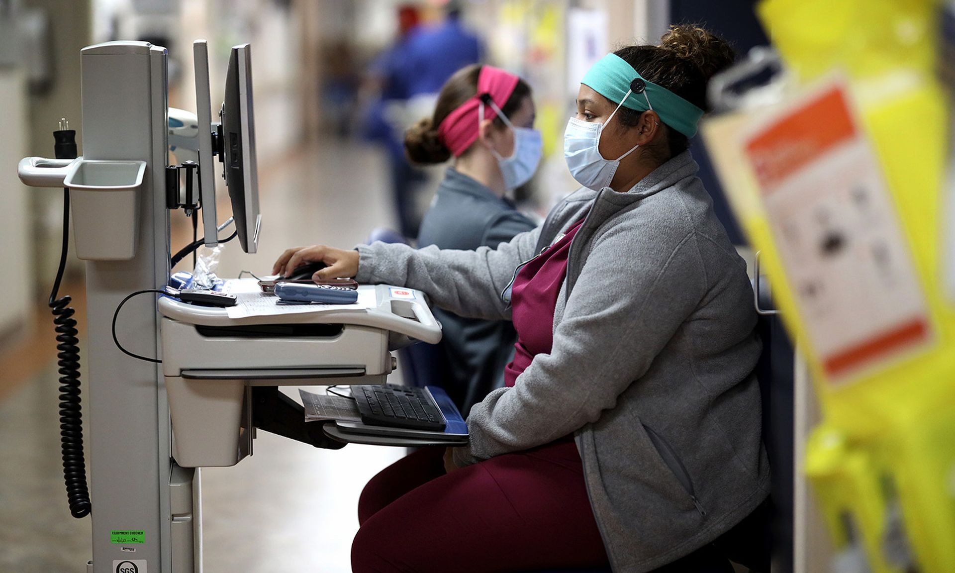 Nurses work outside of the room of a coronavirus patient on April 8, 2020, at MedStar St. Mary&#8217;s Hospital in Leonardtown, Md. Threat actors are targeting the health care sector with a phishing attack leveraging RTLO Unicode, warns a H-ISAC alert. (Win McNamee/Getty Images)