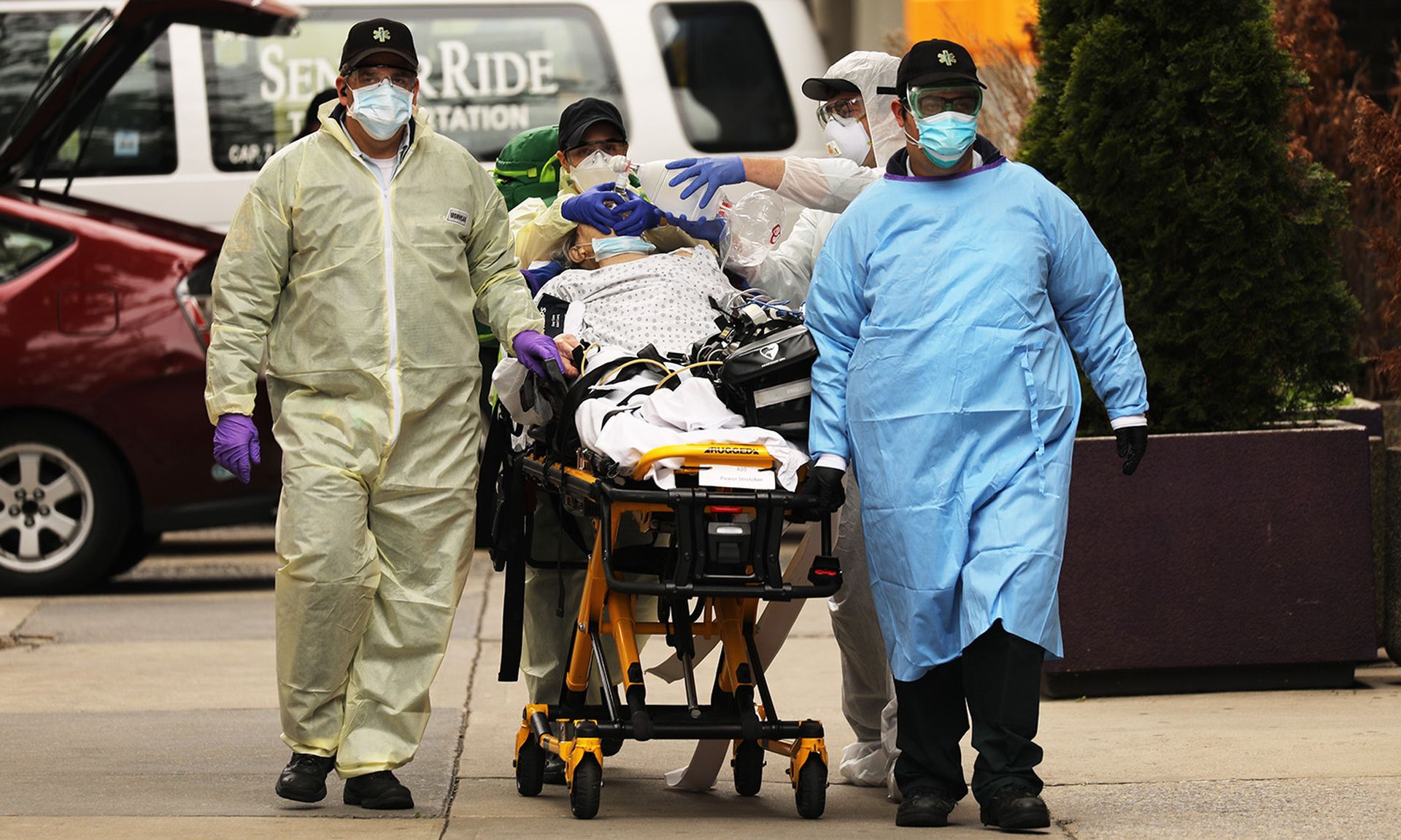 Medics take a patient in severe respiratory distress to an ambulance from a group home next to Maimonides Medical Center on May 11, 2020, in the Borough Park neighborhood of the Brooklyn borough of New York City. (Photo by Spencer Platt/Getty Images)