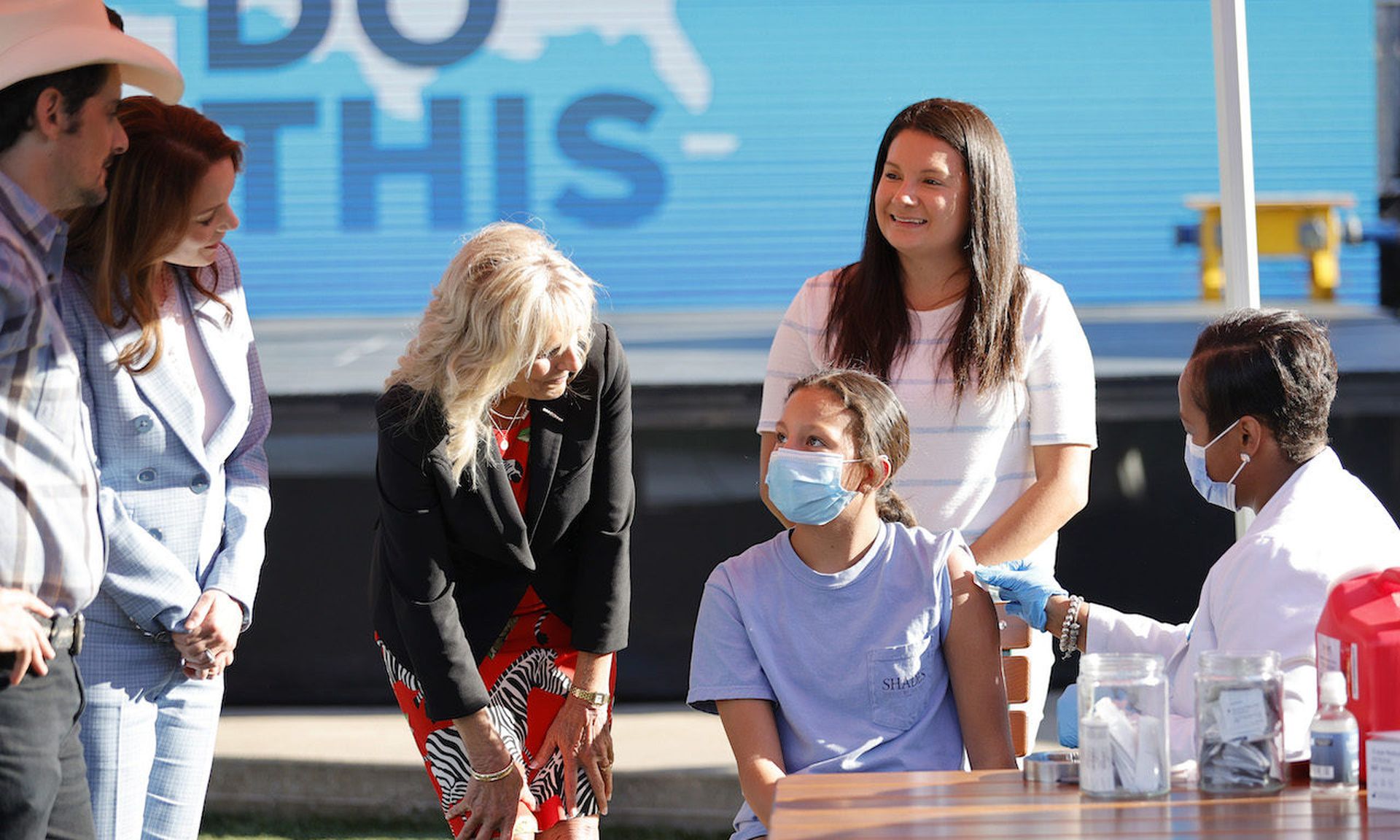 Singer Brad Paisley, Kimberly Williams-Paisley, and First Lady Jill Biden tour a Pop-Up Vaccination site this past June in Nashville, Tenn. Today’s columnist, Bert Kashyap of SecureW2, says as more people are vaccinated, companies will have to make some tough decisions about hybrid work environments. (Photo by Jason Kempin/Getty Images)