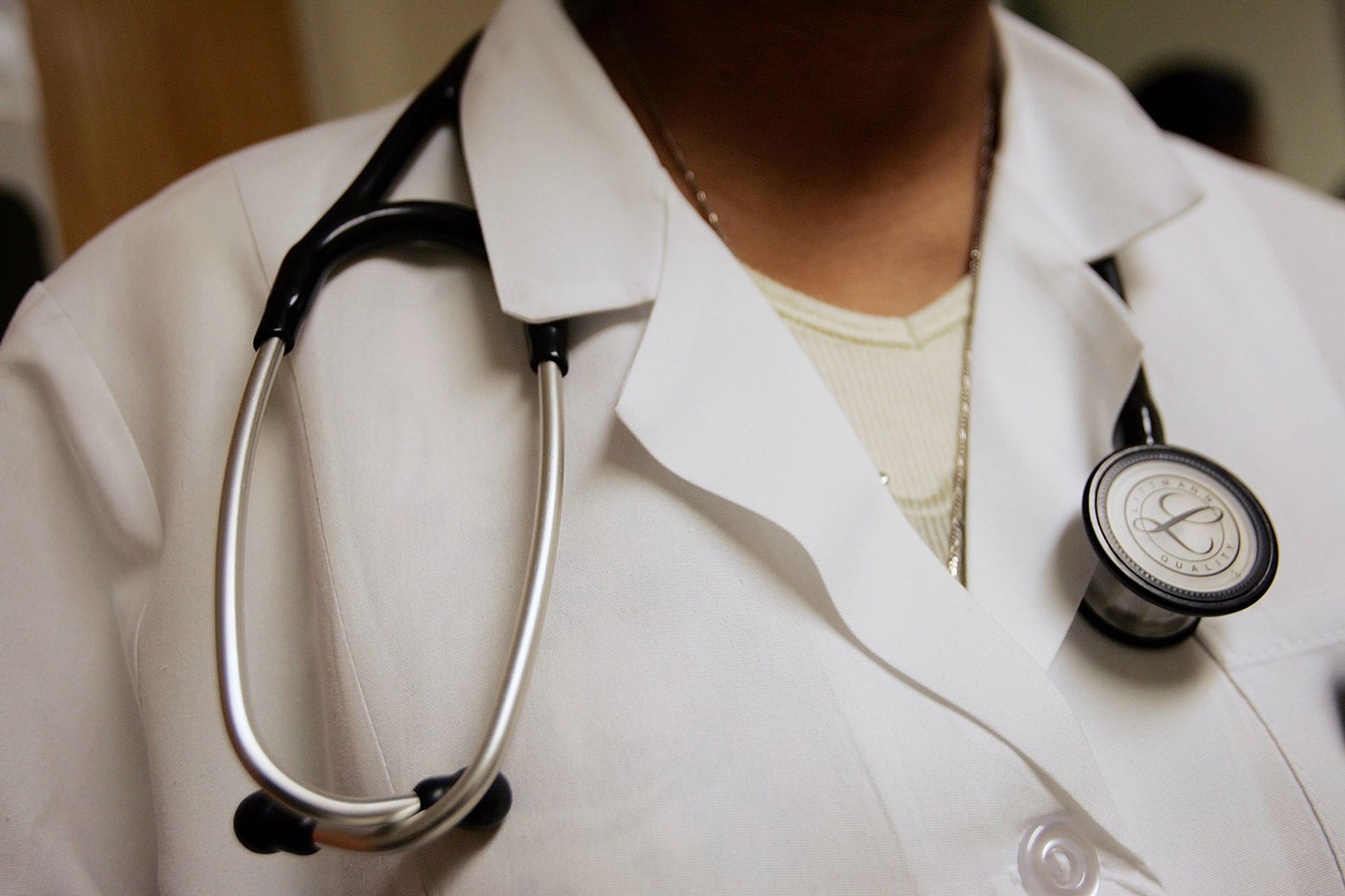 Dominique Entzminger, a physician assistant of family medicine, wears a stethoscope during an examination at the Codman Square Health Center April 5, 2006, in Dorchester, Mass. (Photo by Joe Raedle/Getty Images)