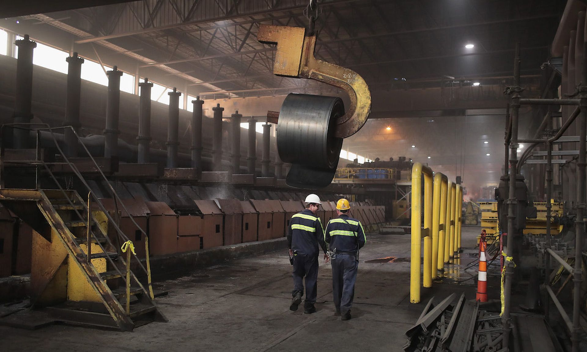 Workers walk through the production line of a steel mill in Indiana. Many organizations with operational technology struggle for secure integration with the IT infrastructure. (Photo by Scott Olson/Getty Images)