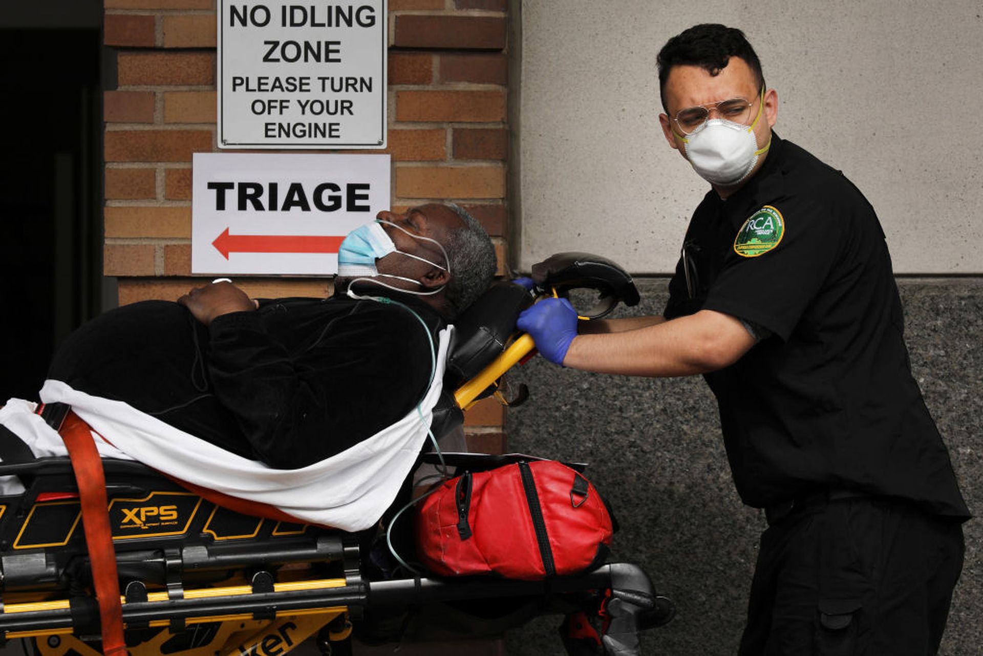 Medical workers take in patients at a special coronavirus intake area at Maimonides Medical Center on April 7, 2020, in New York City. (Photo by Spencer Platt/Getty Images)