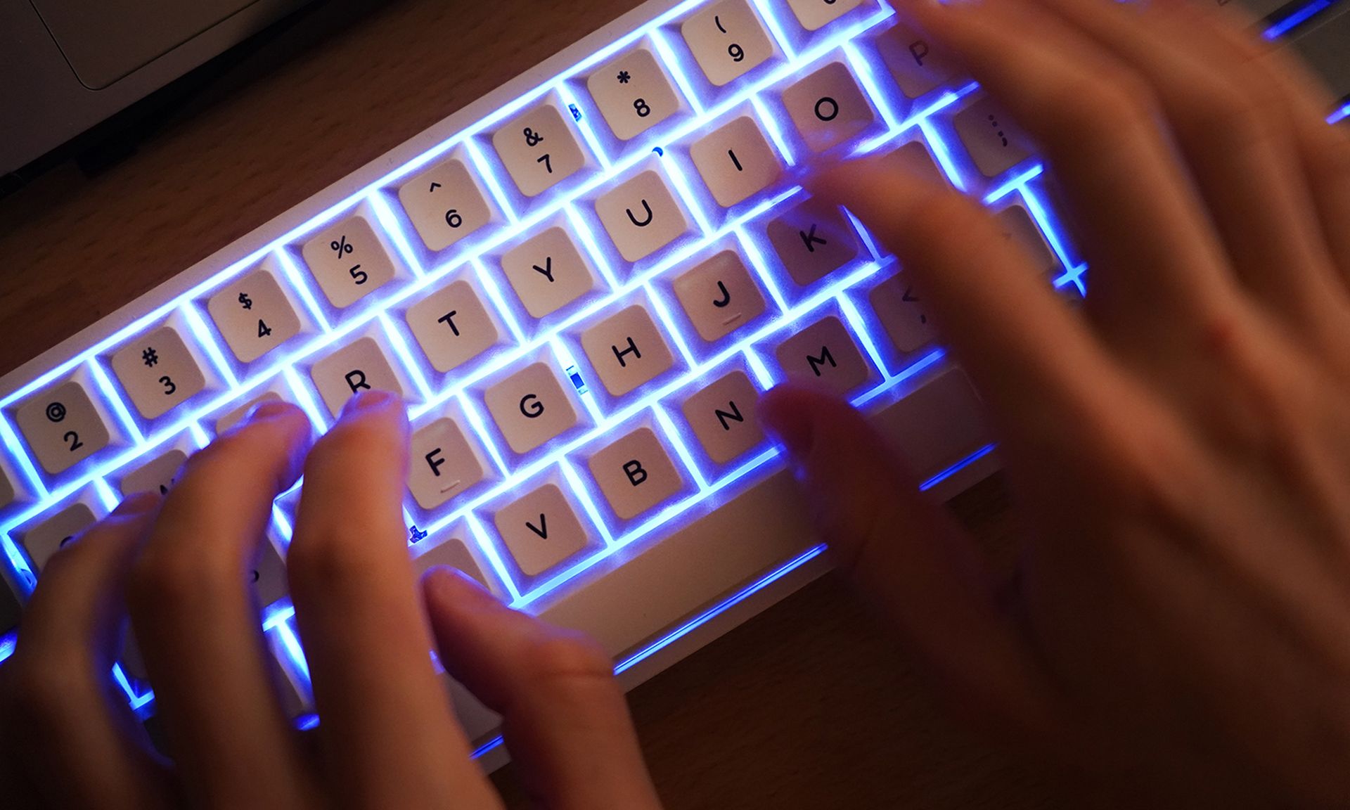 BERLIN, GERMANY &#8211; JANUARY 25: In this photo illustration a young man types on an illuminated computer keyboard typically favored by computer coders on January 25, 2021 in Berlin, Germany. 2020 saw a sharp rise in global cybercrime that was in part driven by the jump in online retailing that ensued during national lockdowns as governments soug...