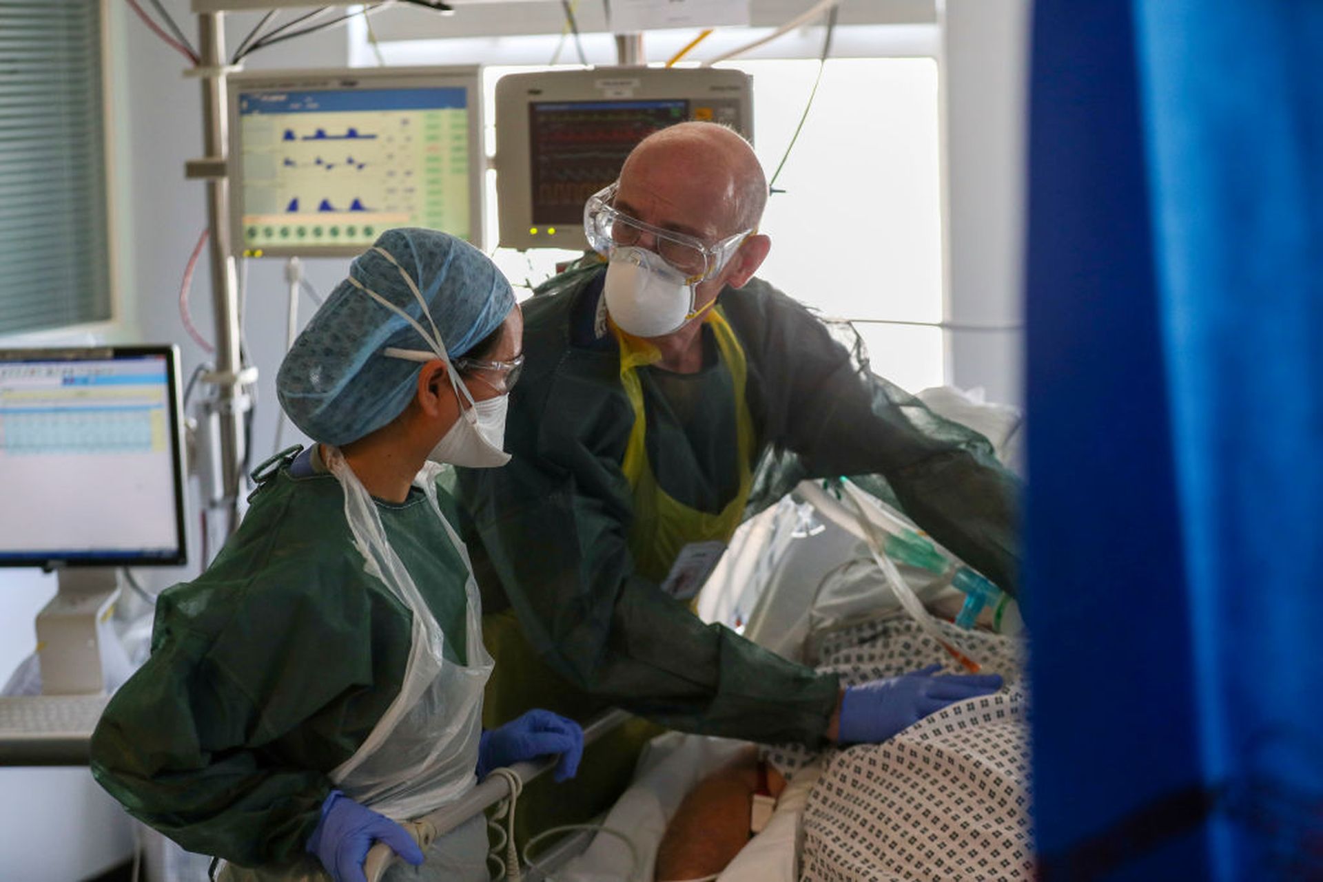 Doctors treat a patient suffering from coronavirus on an Intensive Care ward at Frimley Park Hospital in Surrey on May 22, 2020 in Frimley, United Kingdom. (Photo by Steve Parsons/Getty Images via pool)