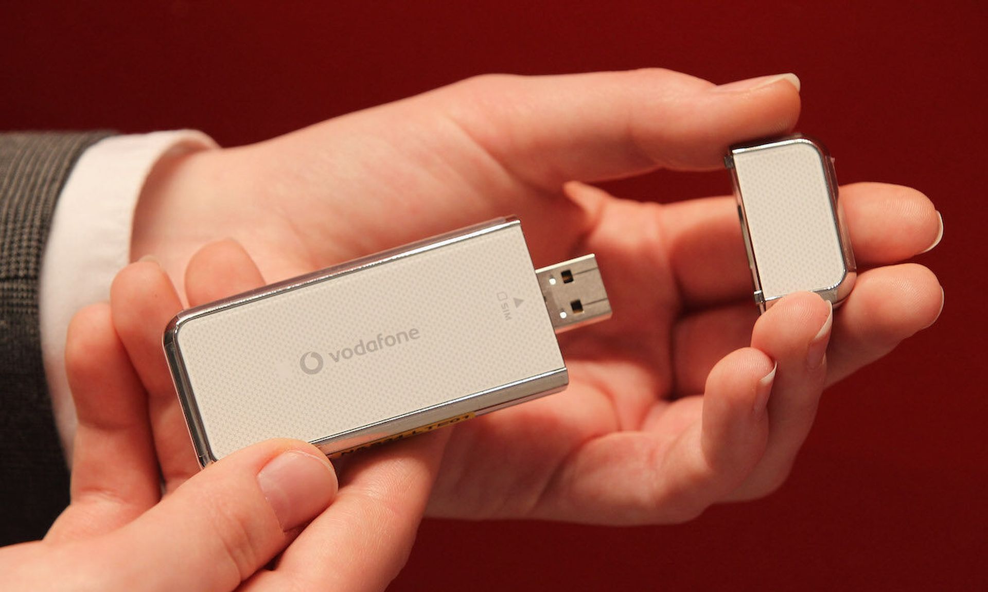 A hostess presents a Vodafone LTE high-speed USB dongle at the Vodafone stand at the 2011 CeBIT technology trade fair in Hanover, Germany. Today’s columnist, Neel Lukka of CurrentWare, offers several tips for security teams looking to protect their companies from the risks of USB drives. (Photo by Sean Gallup/Getty Images)