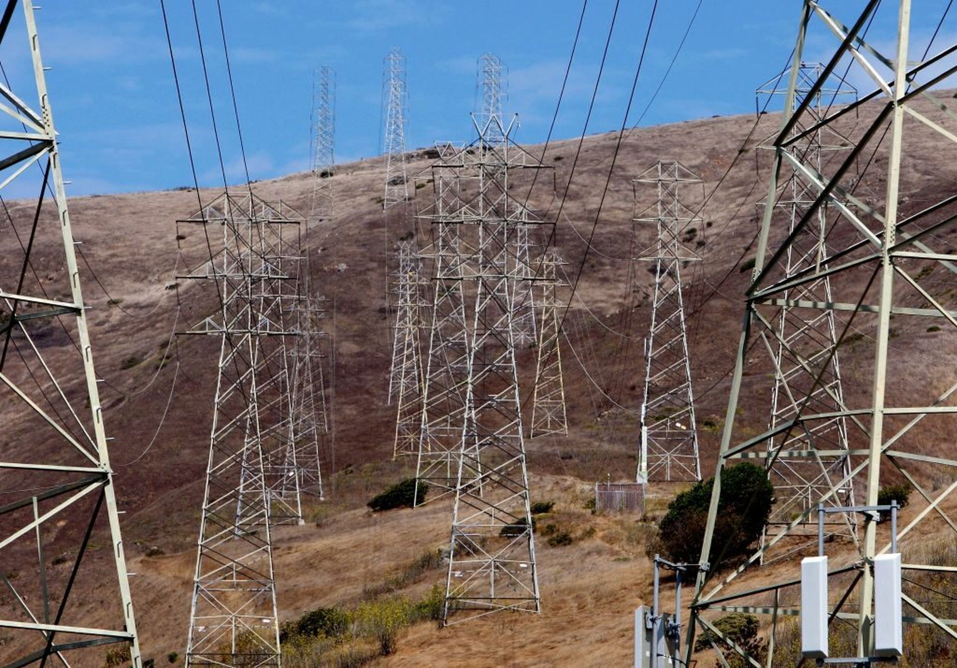 Towers carrying electrical lines are shown Aug. 30, 2007, in South San Francisco, Calif. Federal agencies and policymakers are eyeing a mix of voluntary collaboration and financial incentives to prod critical infrastructure entities to slowly replace past technologies and processes that have traditionally prioritized availability and reliability ov...