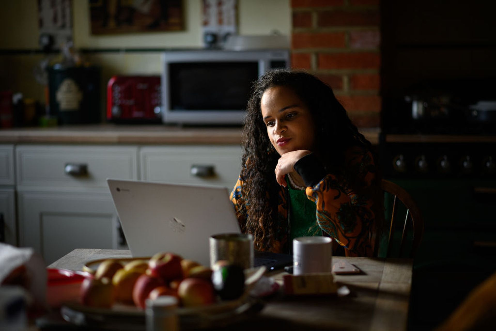 LONDON, ENGLAND &#8211; JUNE 02: Crisis Volunteer and Coach Lauren Duncan sits with her laptop in the kitchen, where she usually logs on for her shifts with the crisis text service Shout 85258 on June 02, 2020 in the Woodside Park area of London, United Kingdom. While studying for her psychology degree, discovering that it isn&#8217;t usually an ad...