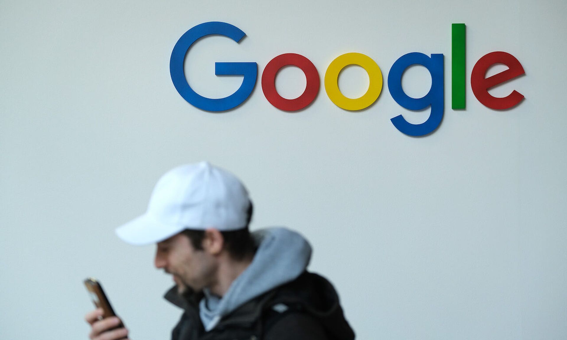 BERLIN, GERMANY &#8211; MAY 06: A visitor speaks into a smartphone while standing next to the Google stand at the re:publica 19 series of conferences on May 06, 2019 in Berlin, Germany. The three-day gathering hosts speakers and events to discuss the many facets of digital society, including topics such as media, entertainment, politics, culture an...