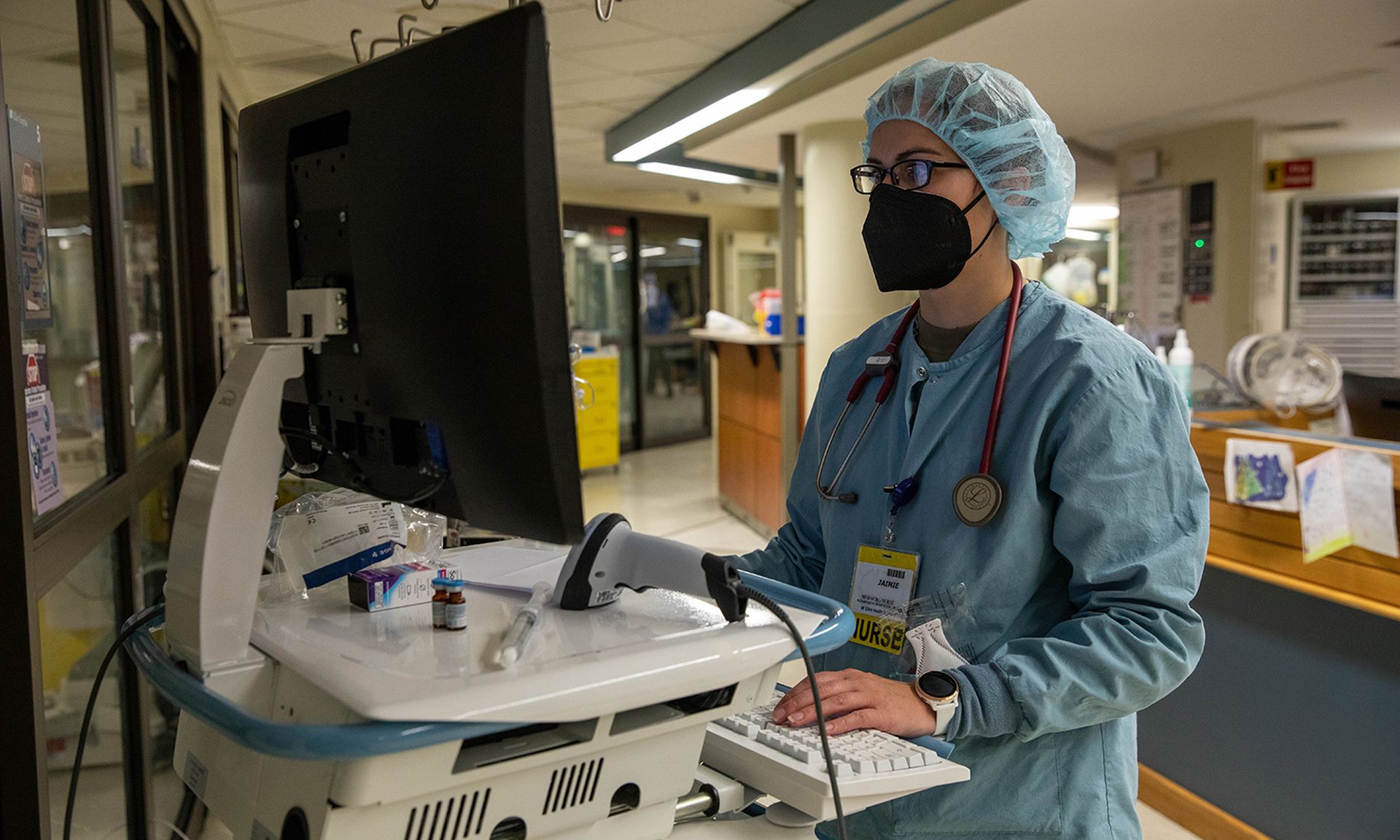 ir Force Maj. Jamie Laib, a nurse assigned to the medical augmentation team deployed to Manchester, N.H., uses a hospital computer as part of the COVID response operations at Elliot Hospital, Jan. 14, 2022. (Sgt. Kaden D. Pitt/U.S. Army)