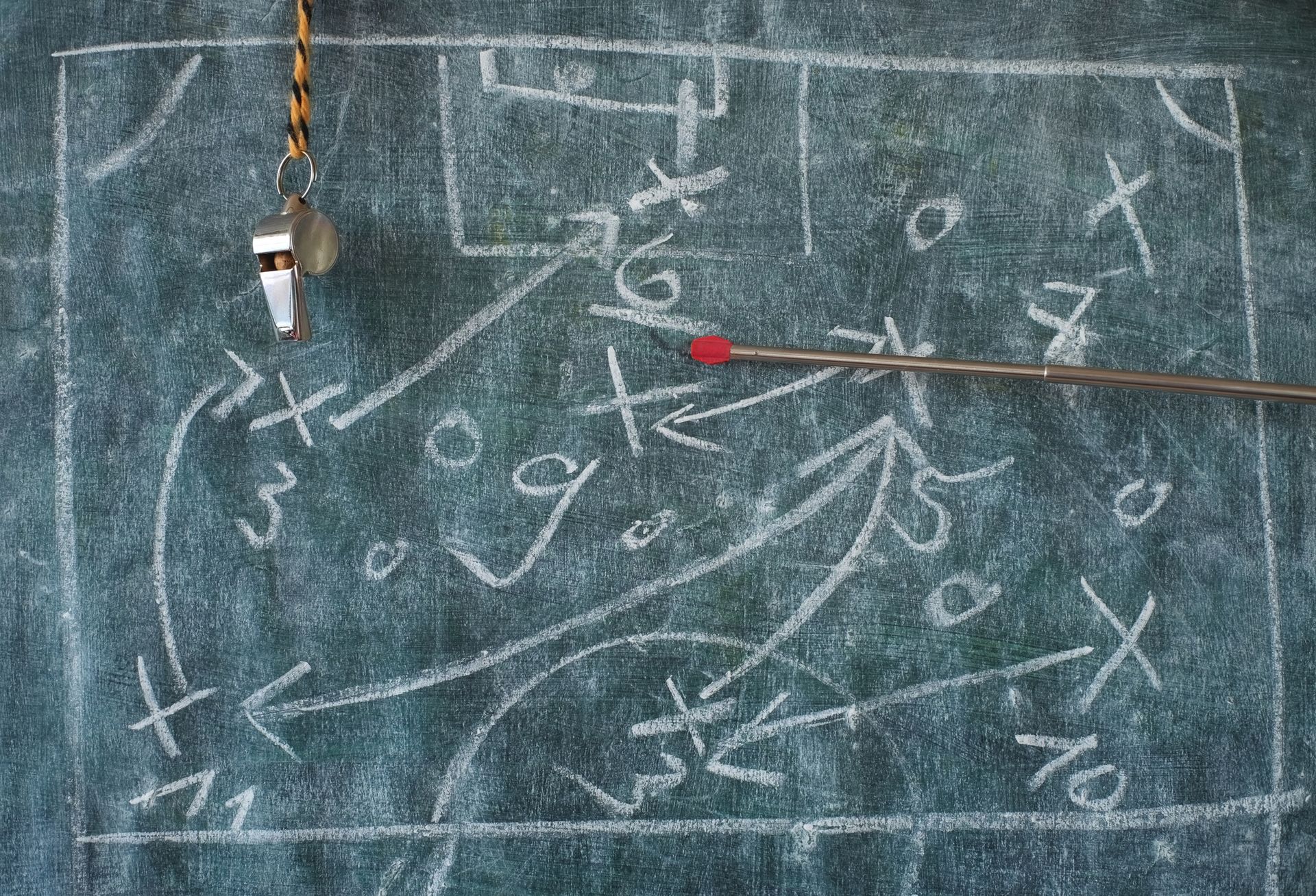 Soccer or football tactics scribble with the trainers whistle and pointer stick on blackboard. Great soccer event this year