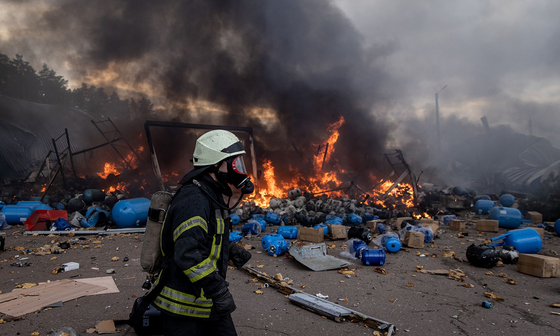 Firefighters try to extinguish a fire after a chemical warehouse was hit by Russian shelling on the eastern frontline near Kalynivka village on March 8, 2022, in Kyiv, Ukraine. (Photo by Chris McGrath/Getty Images)