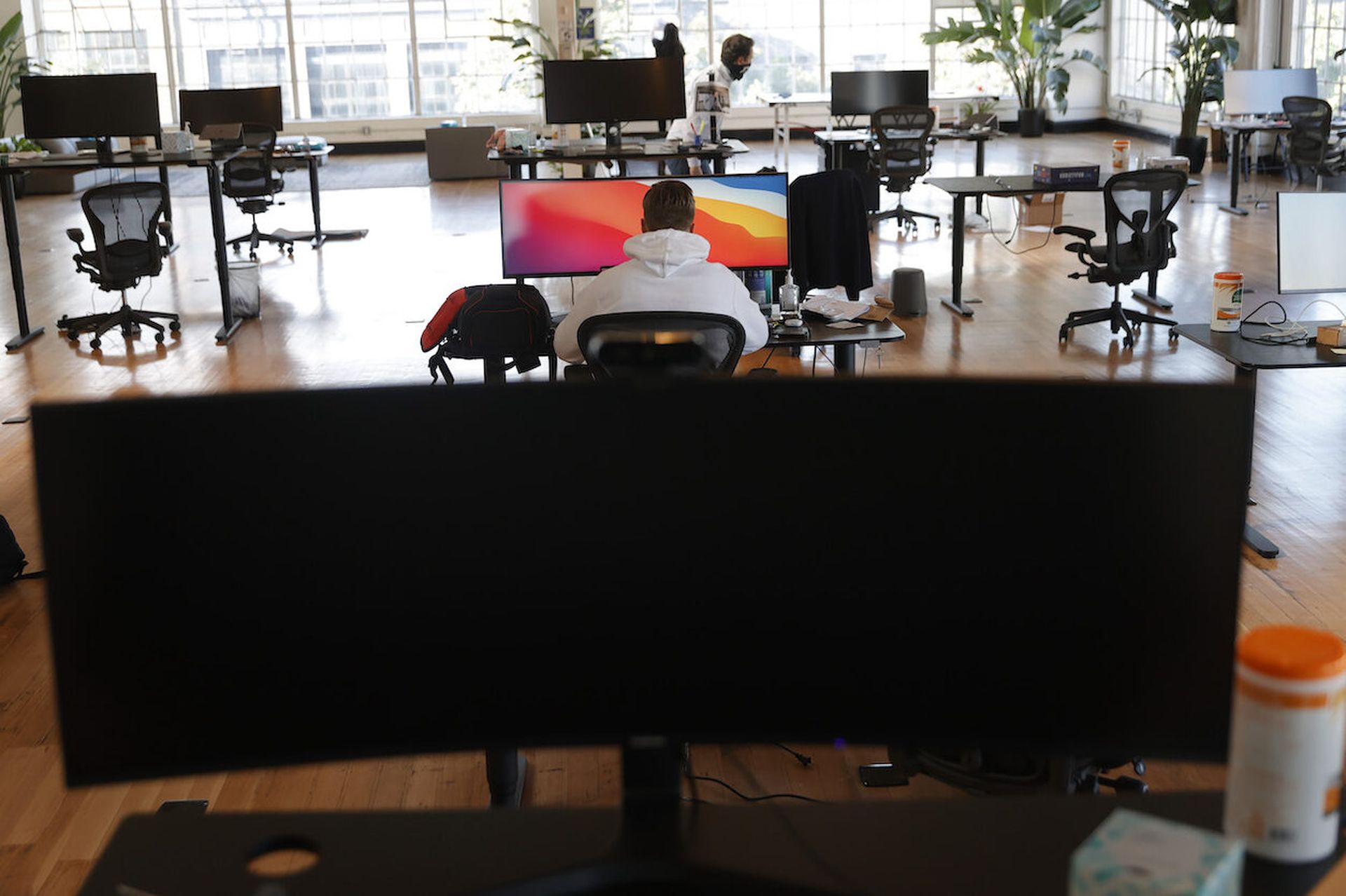 Vlad Lapich, with tech startup company Fast, works on his computer on the first day back in the office on March 24, 2021 in San Francisco, California. A limited number of employees at a tech company in San Francisco returned to work in the office as San Francisco and 5 other California counties moved into the orange tier of reopening. The orange ti...