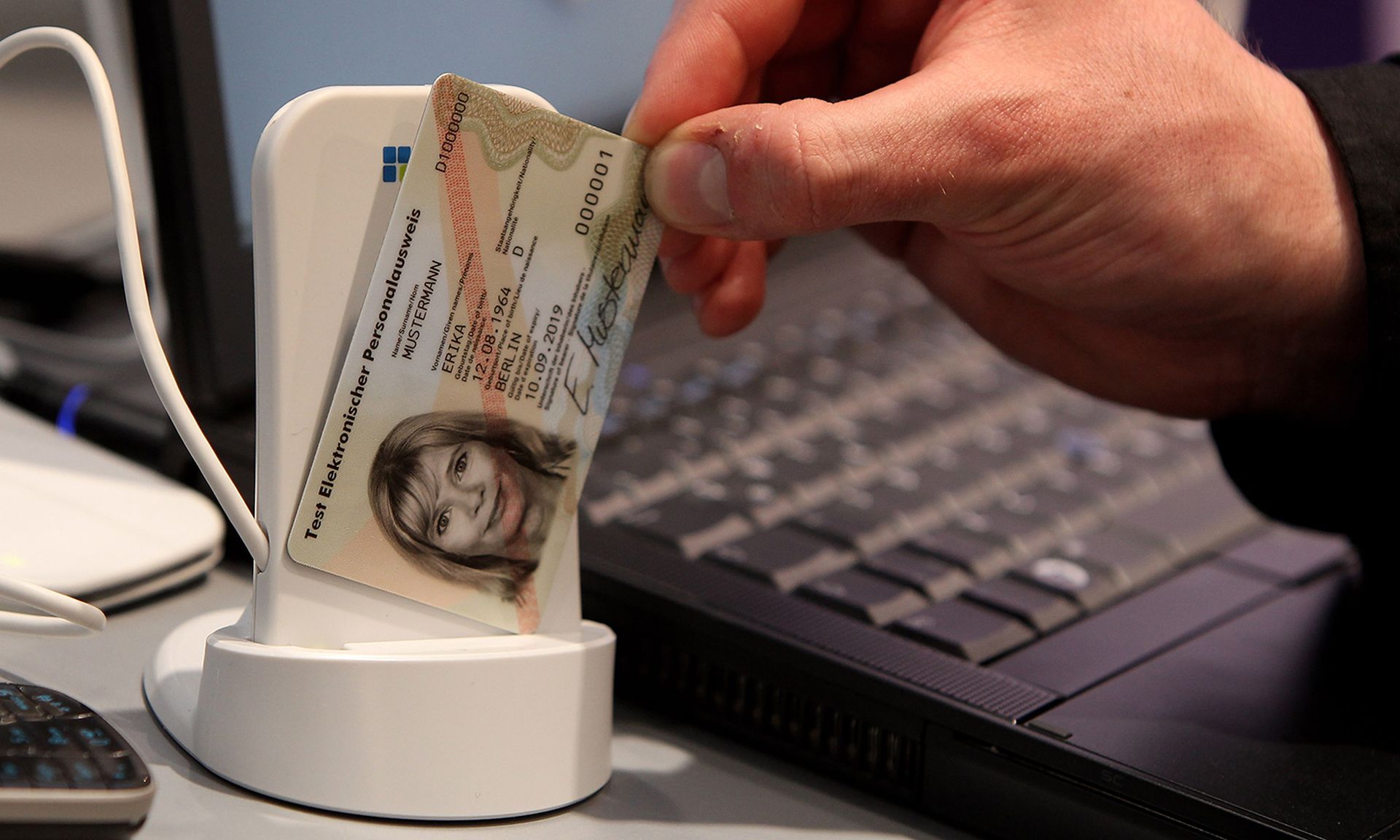 Criminals reverted to pre-pandemic techniques such as bots, malware and a variety of identity fraud scams in 2021. Pictured: A host displays a sample of a new German national identity card and a coupled data scanner at the Fraunhofer Institute stand at the CeBIT Technology Fair on March 2, 2010, in Hannover, Germany. (Photo by Sean Gallup/Getty Ima...