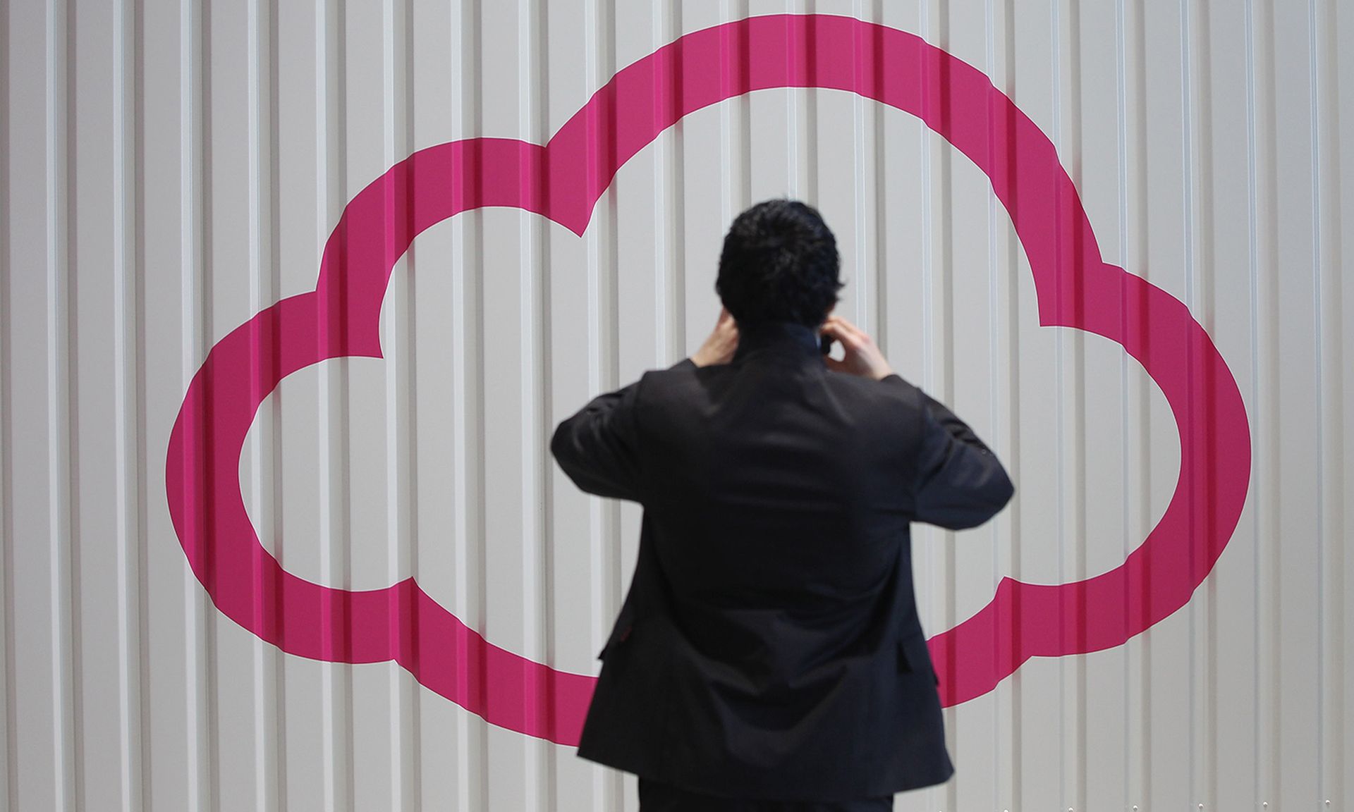 A visitor photographs a symbol of a cloud at the CeBIT 2012 technology trade fair on March 5, 2012, in Hanover, Germany. (Photo by Sean Gallup/Getty Images)