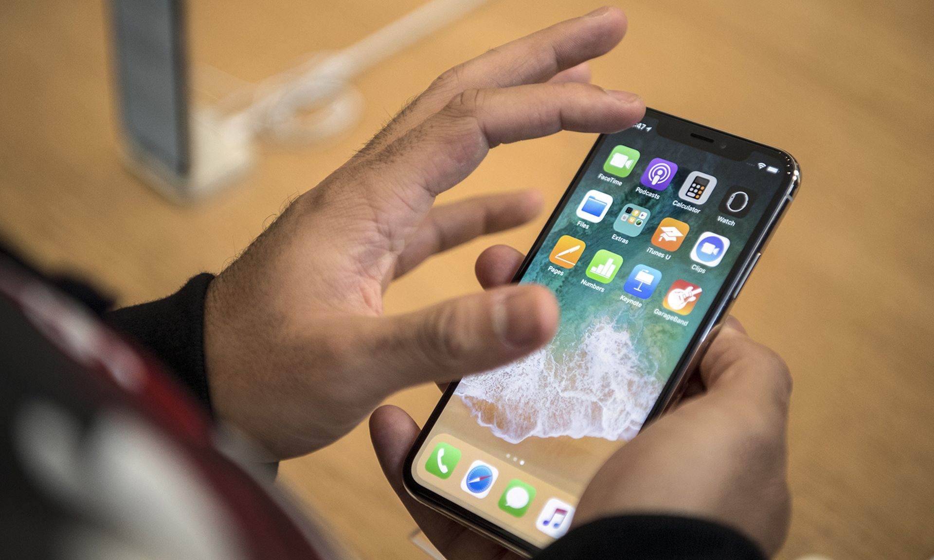 A customer views the iPhone X upon its release in the UK on Nov. 3, 2017, in London. (Photo by Carl Court/Getty Images)