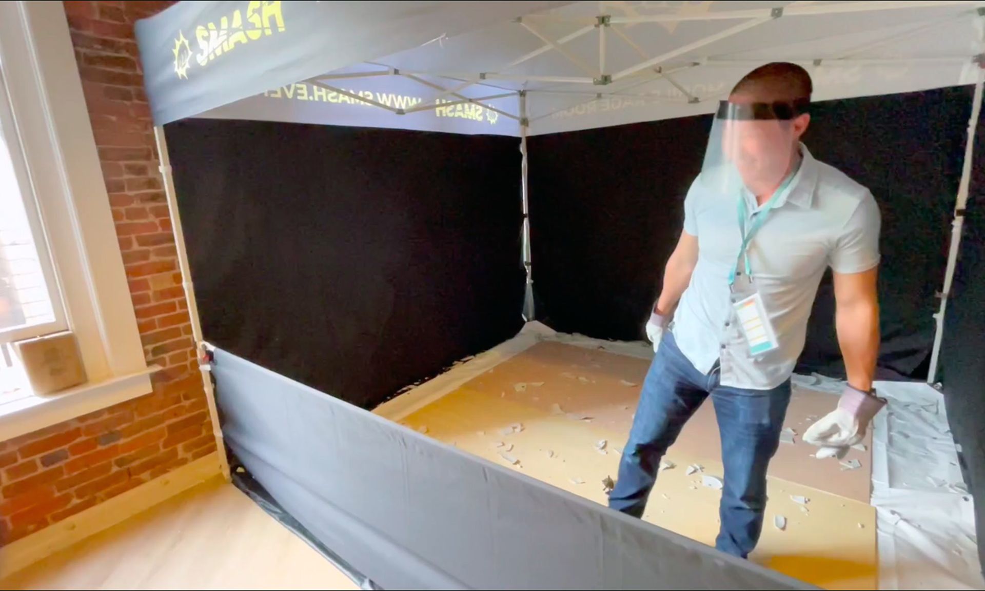 An attendee destroys a plate in a makeshift rage room at the RSA Conference.