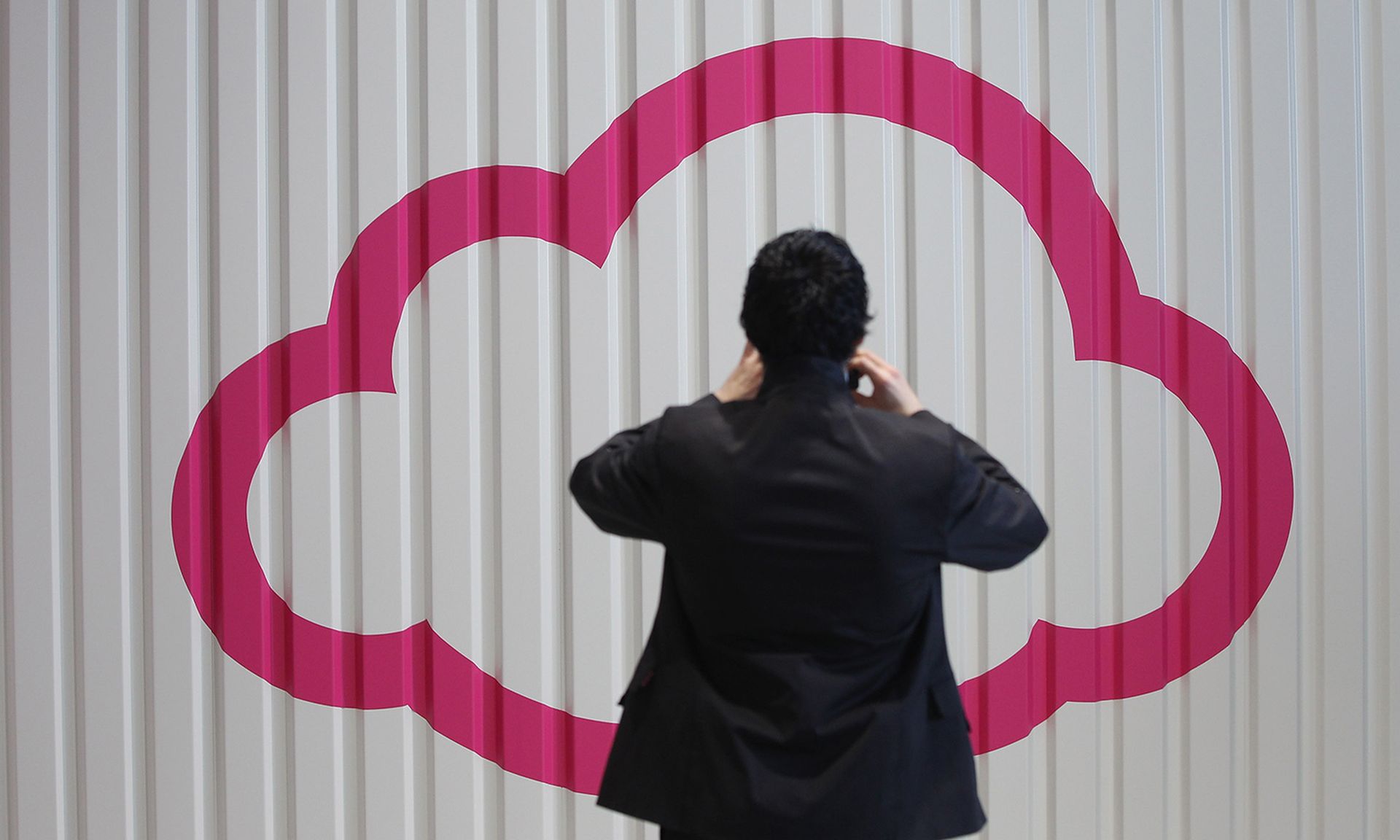 ZScaler’s Posture Control is designed to give DevOps and security teams the ability to prioritize and remediate risks in cloud-native applications. Pictured: A visitor photographs a symbol of a cloud at the CeBIT 2012 technology trade fair on March 5, 2012, in Hanover, Germany. (Photo by Sean Gallup/Getty Images)