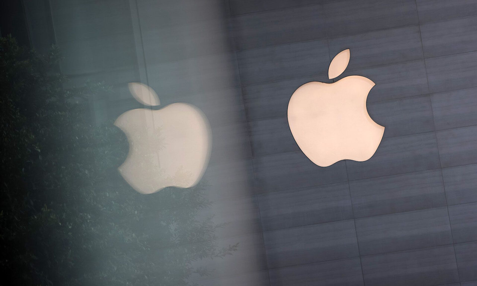 An Apple logo is reflected on glass at the Apple Store at Orchard Road on September 24, 2021 in Singapore. Apple announced September 14 the release of four variants of its latest iPhone 13, alongside other upgrades to its product lineup. (Photo by Feline Lim/Getty Images)