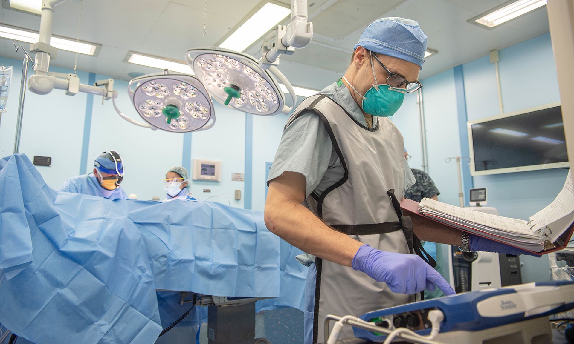 A Navy cardiologist enters patient information into a pacemaker programming system aboard the hospital ship USNS Mercy on April 29, 2020. (Navy)