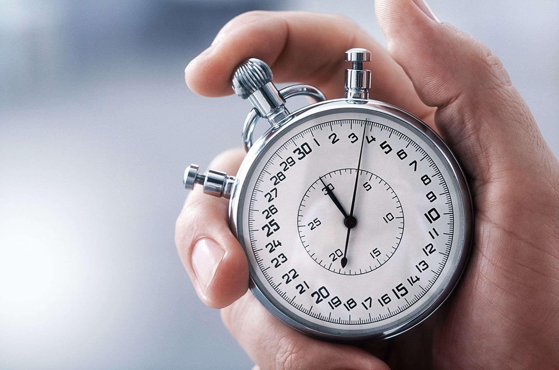 Hand holding a stopwatch