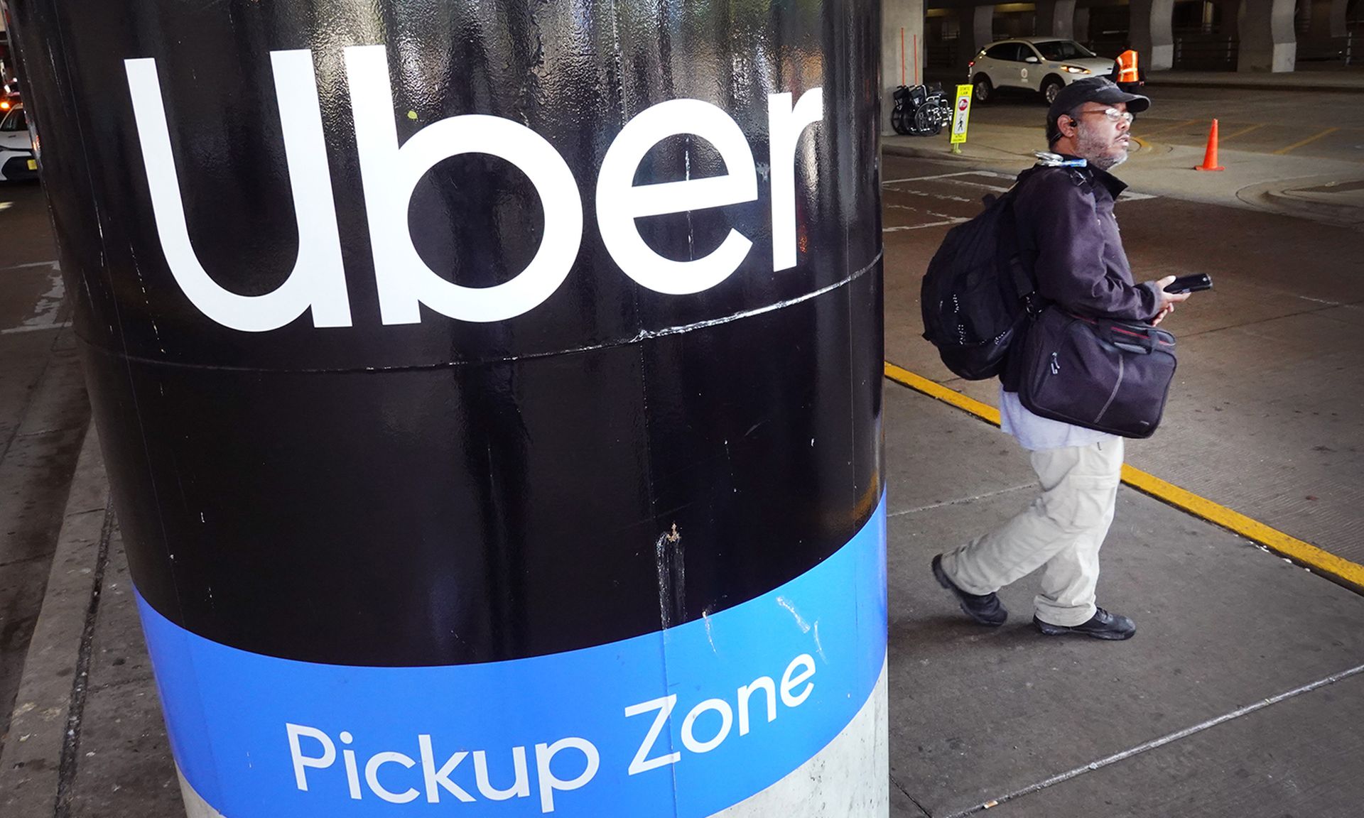 A traveller waits for an Uber rider at Midway International Airport on May 9, 2022, in Chicago. (Photo by Scott Olson/Getty Images)