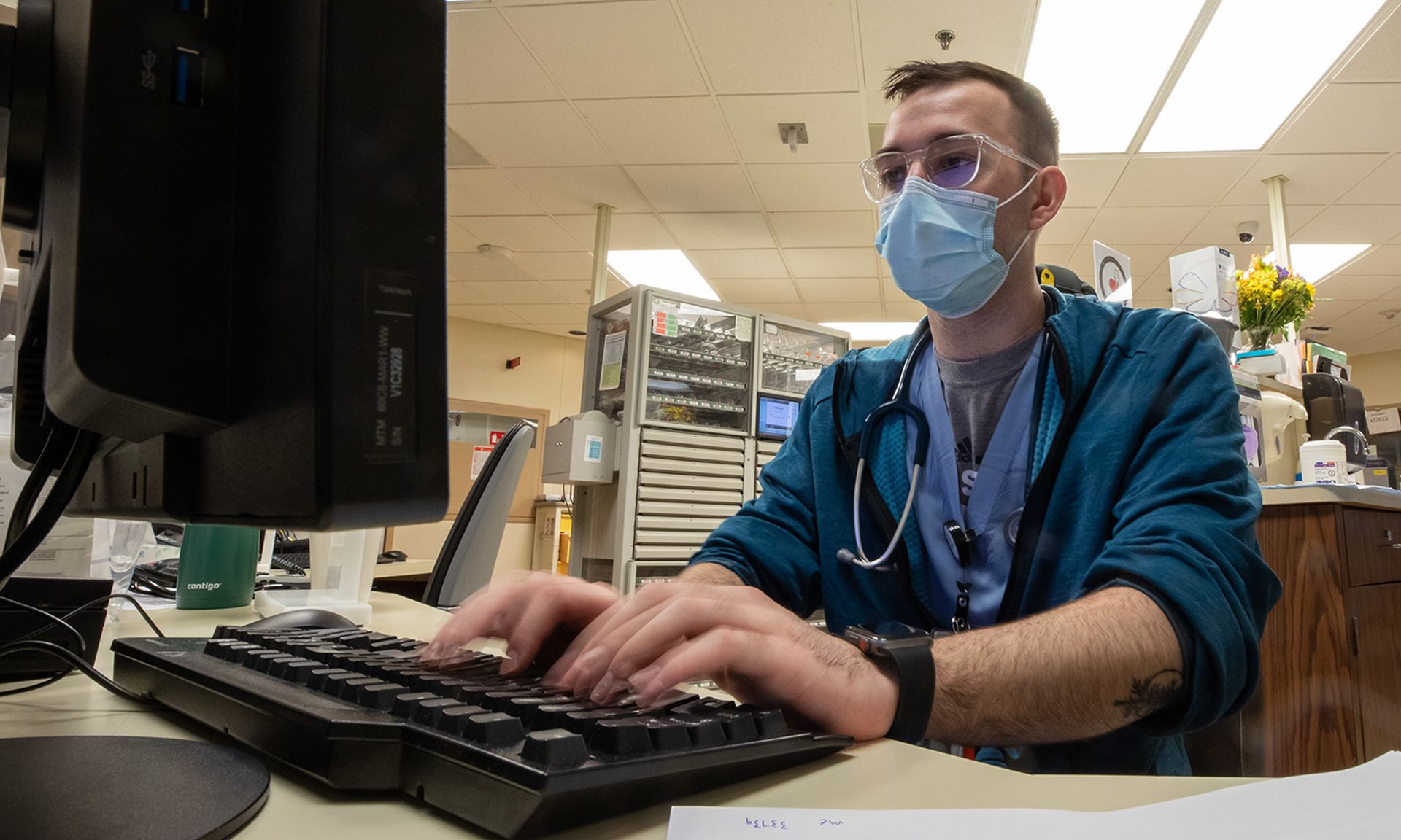 A nurse charts patient care information.