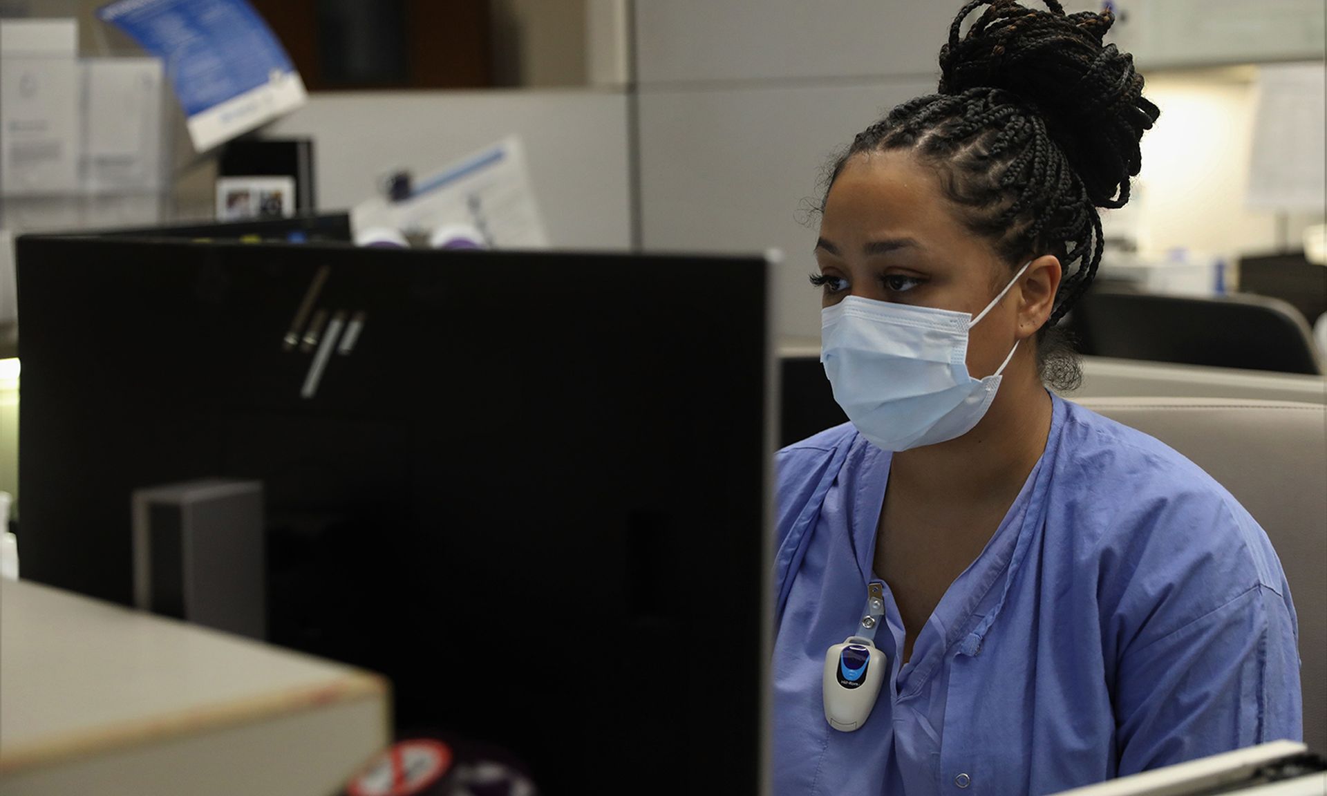 A clinical nurse reviews a patient’s vitals.