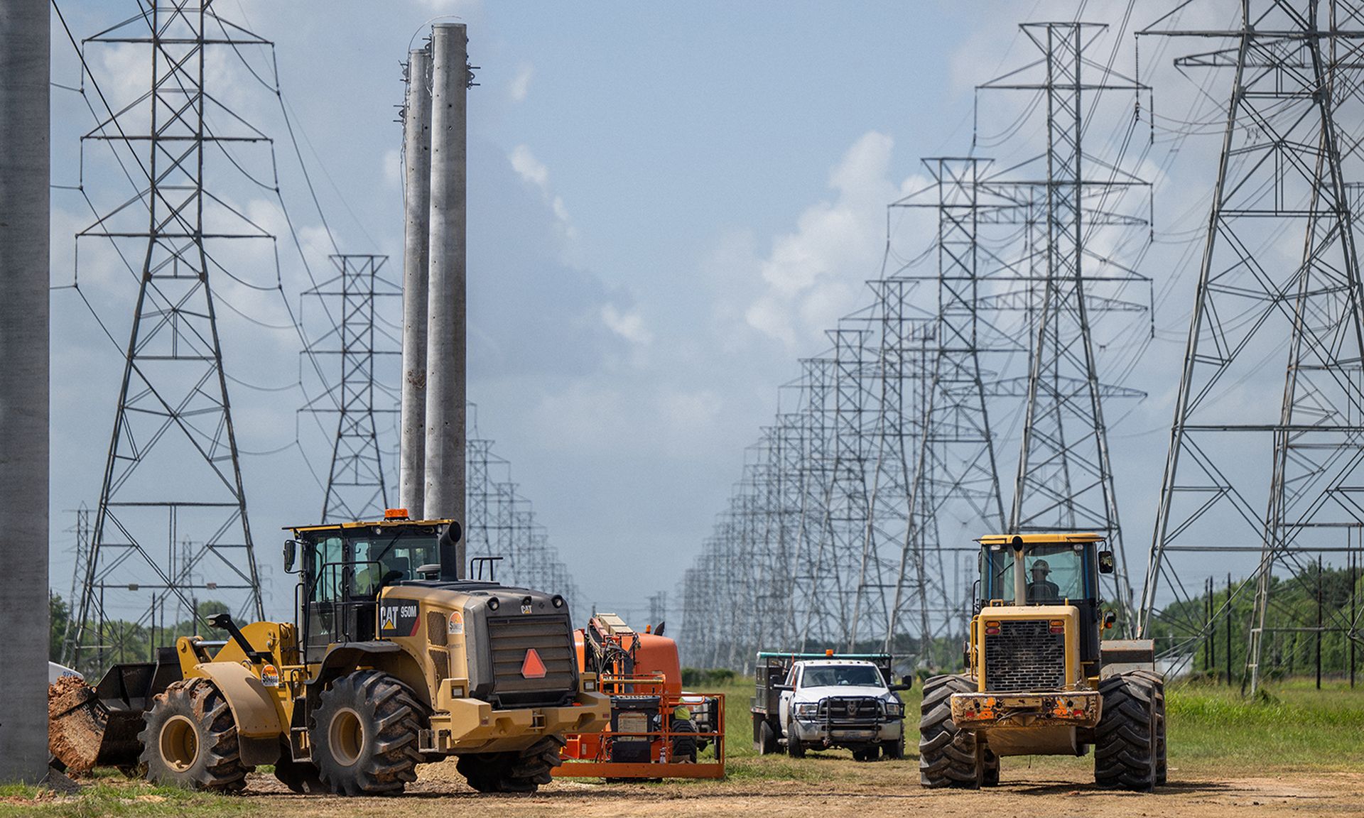 Service technicians work to install the foundation for a transmission tower.