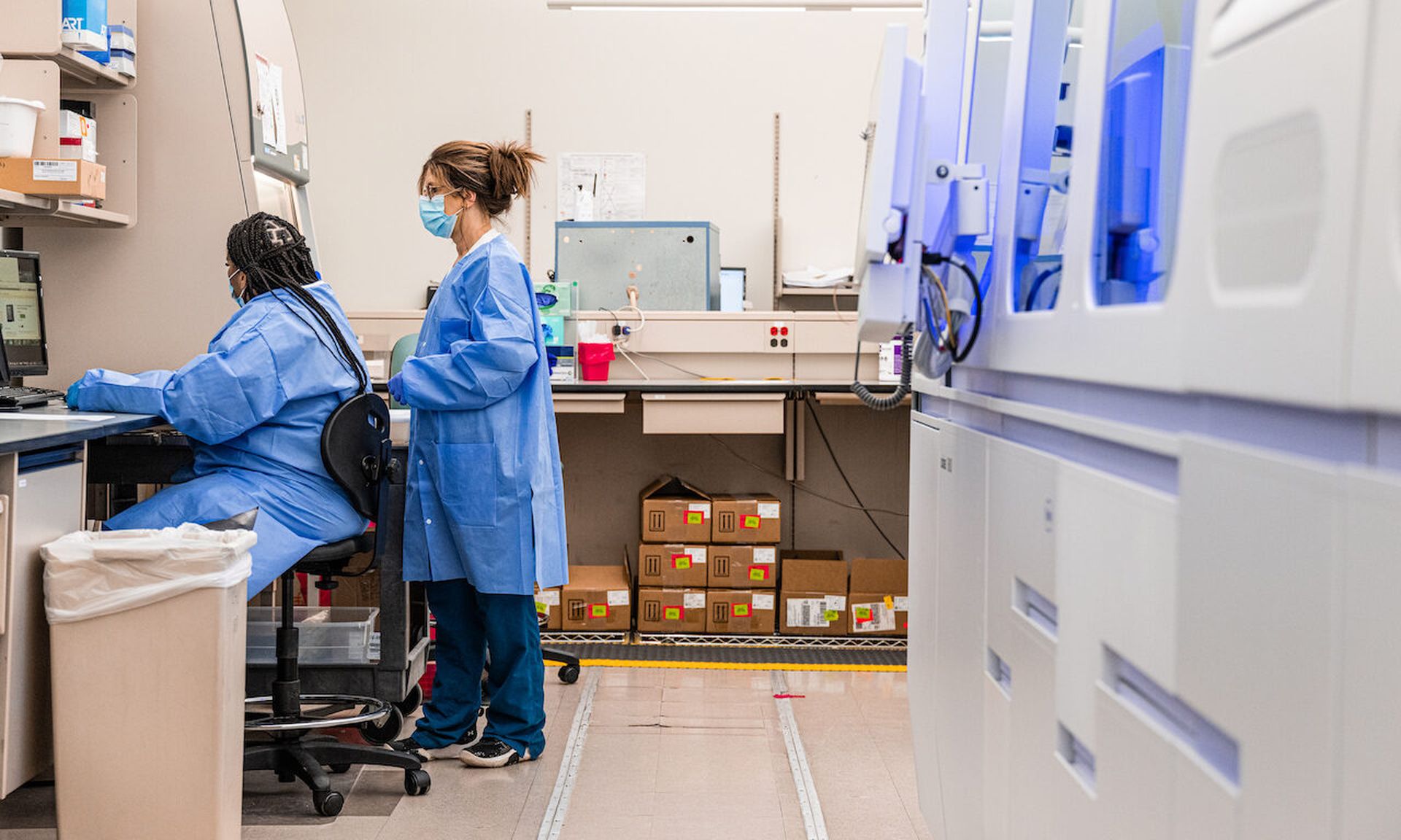 Workers gather at a computer in a testing lab  in Indianapolis, Indiana. The healthcare sector is being targeted by a threat group posing as software vendors. (Photo by Jon Cherry/Getty Images)