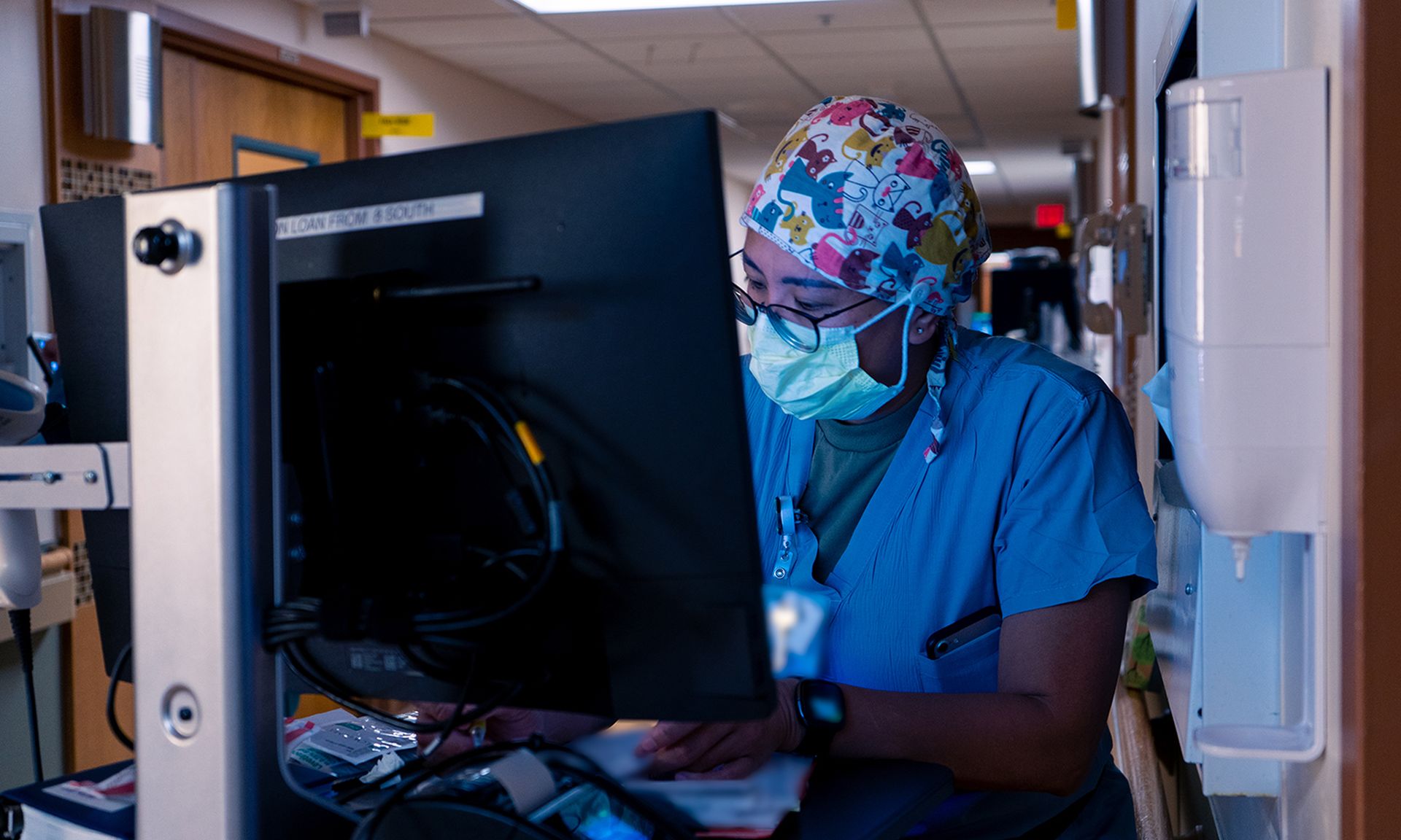 A hospital nurse logs patient information