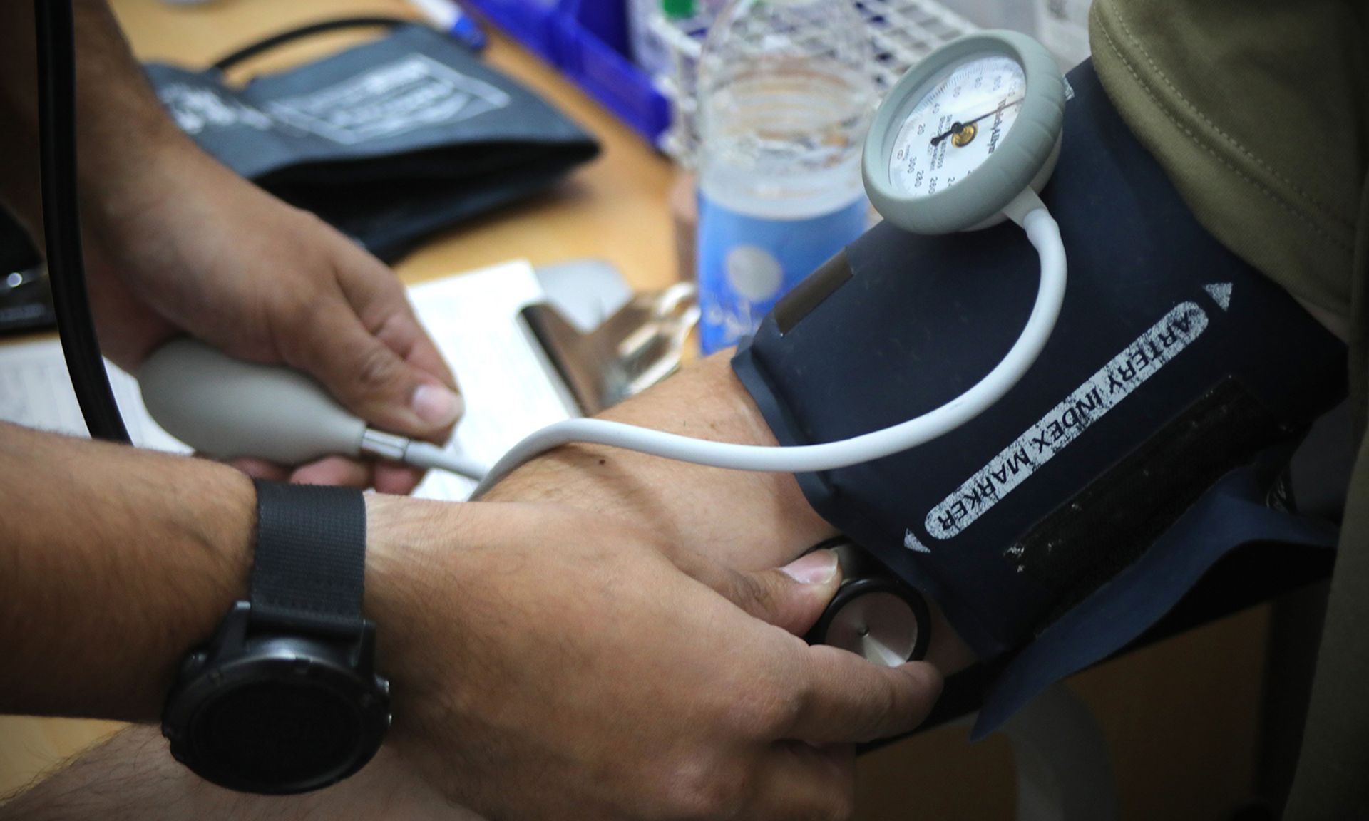 A medic takes vital signs from a donor during a blood drive.