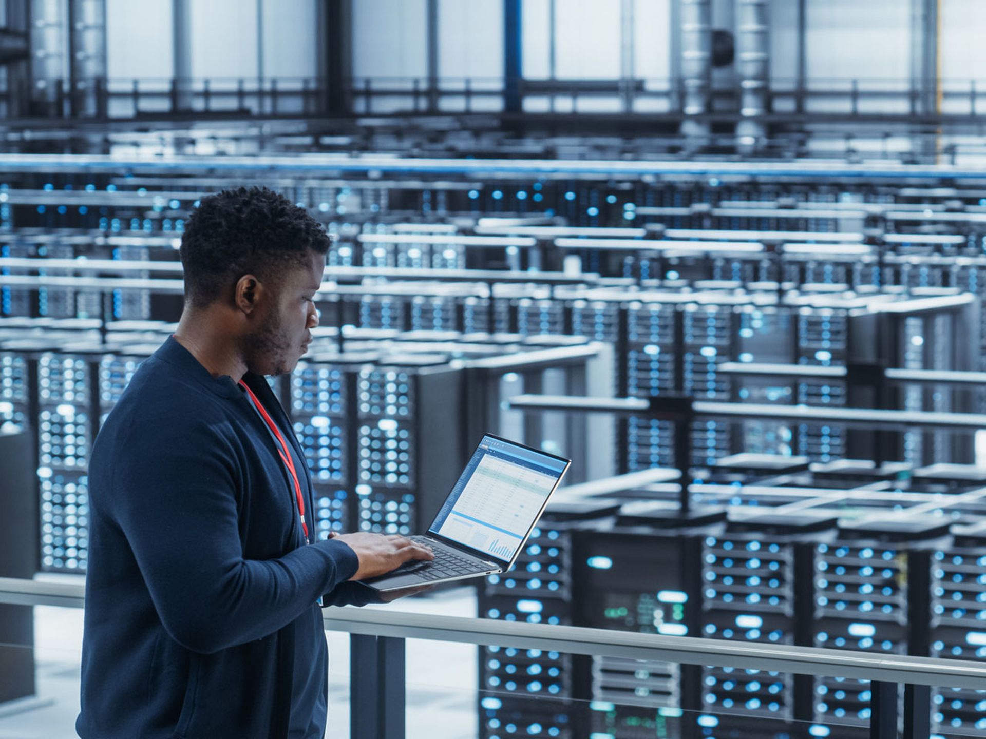 Data Center Engineer Using Laptop Computer.