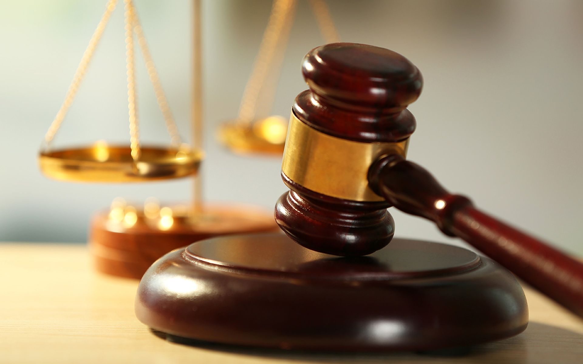 Wooden judges gavel on wooden table, close up