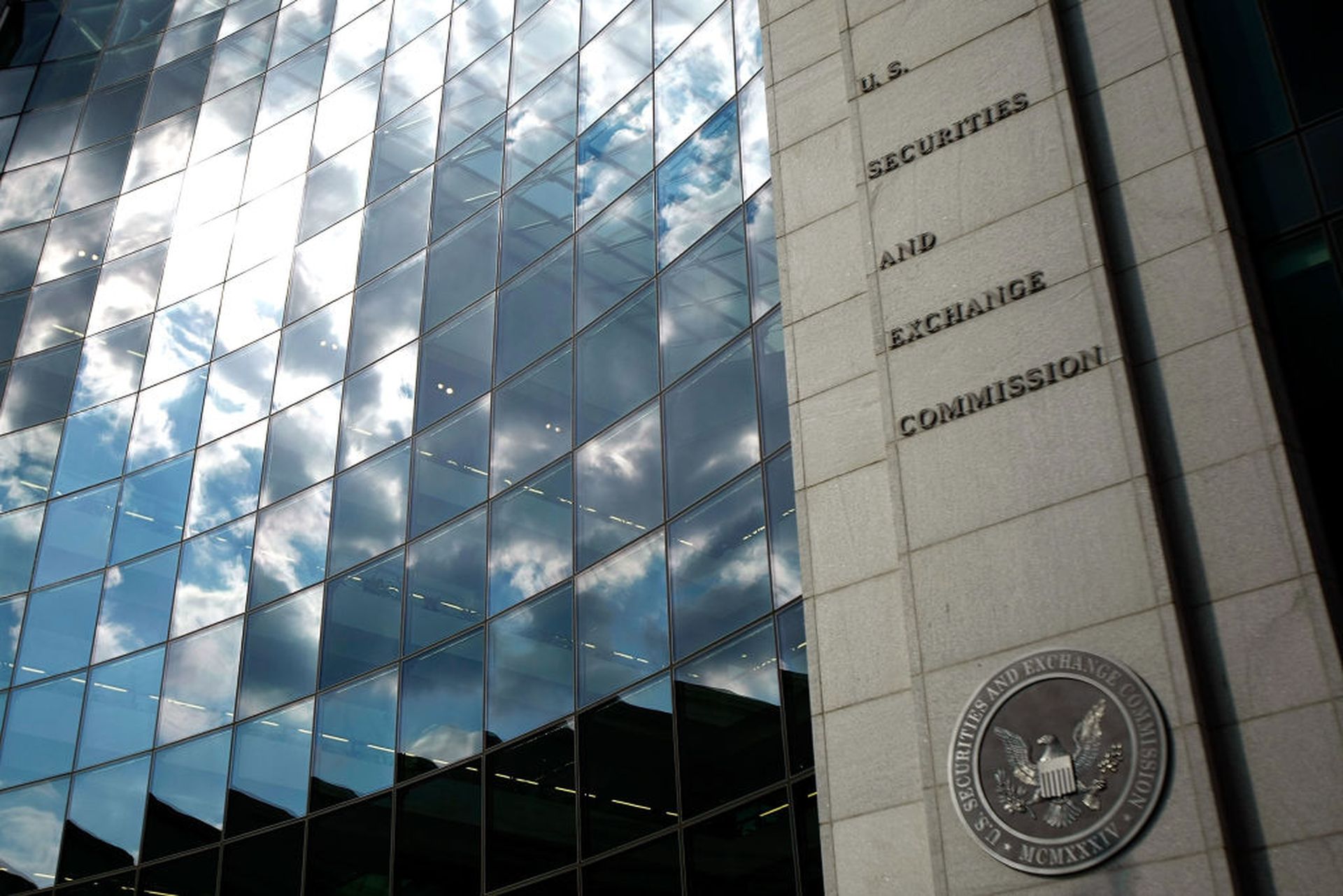 WASHINGTON &#8211; SEPTEMBER 18:  The U.S. Securities and Exchange Commission seal hangs on the facade of its building September 18, 2008 in Washington, DC. Republican presidential candidate Sen. John McCain (R-AZ) has called for the ouster of SEC Chairman Christopher Cox in the wake of the collapse of several giant banks on Wall Street and the res...