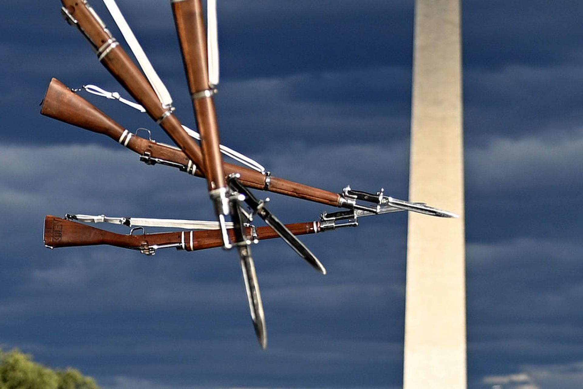 Rifles fly in the air at a drill competition